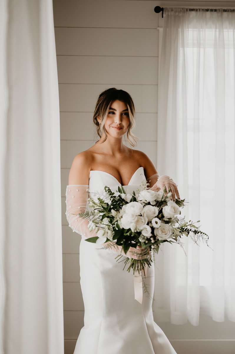 Crimson Lane Wedding Venue Bride with gorgeous dress, and white florals but UBD Florals 