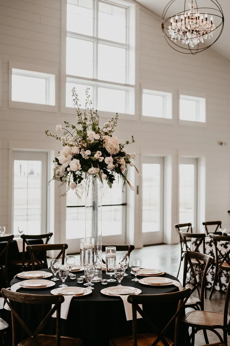 Elegant Tablescape Decorated with Black Linens and Gold Accents at Crimson Lane Wedding Venue - Captured by Julia Brown Photo