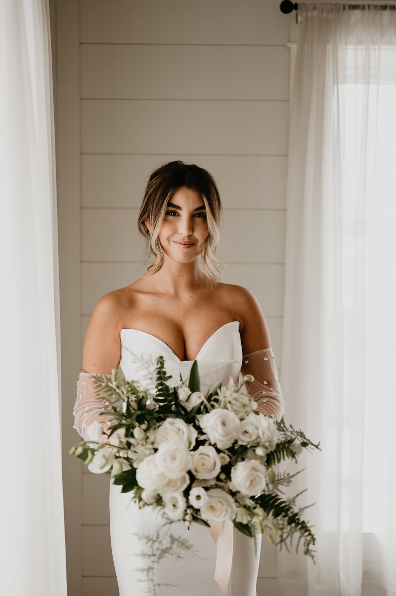 Beautiful Bride in Twirl Dress and Beaded Gloves, Surrounded by Lush UBD Florals