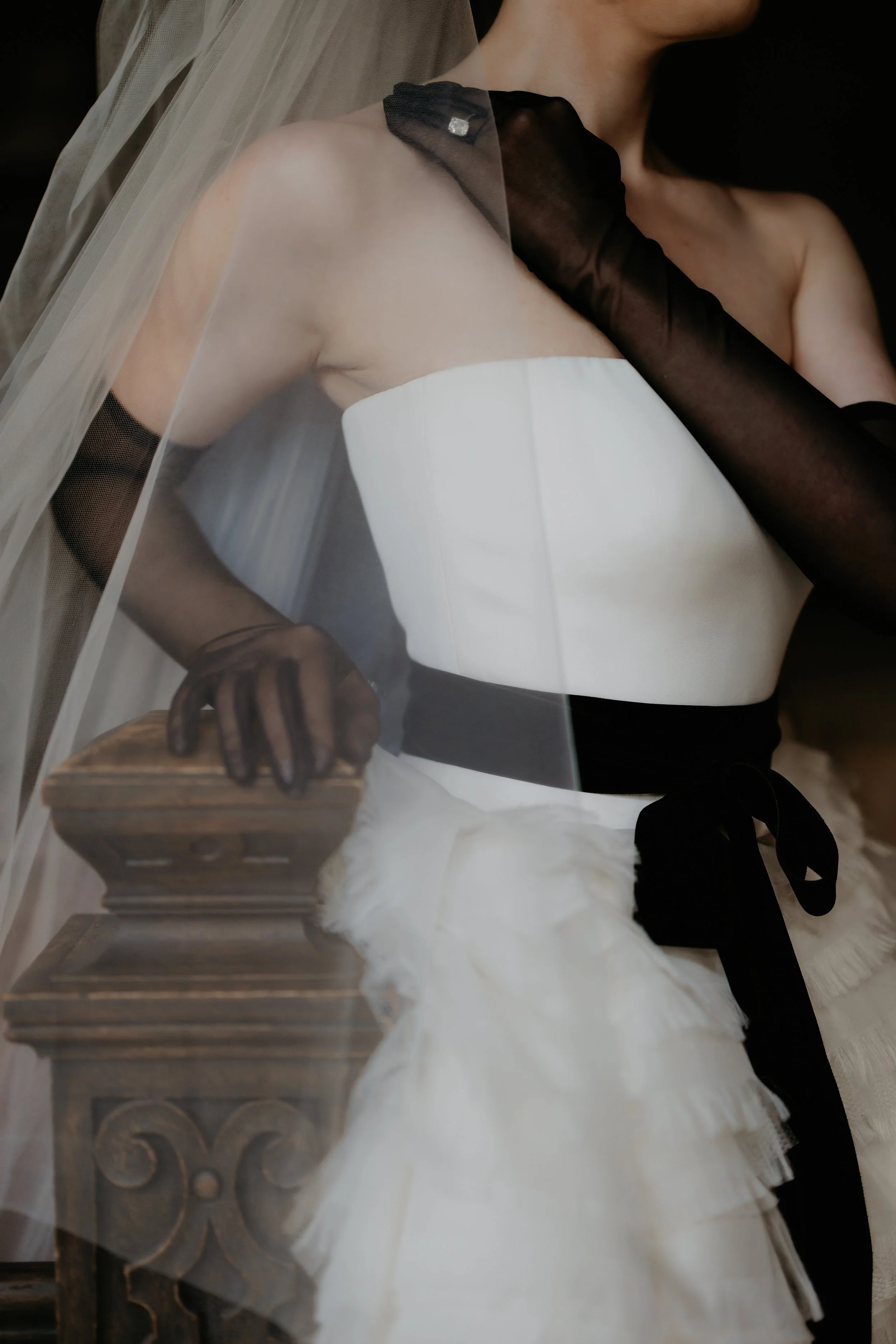 Editorial bridal portrait highlighting black opera gloves, a black velvet sash, and a layered Vera Wang wedding gown, photographed by Julia Brown Photo.