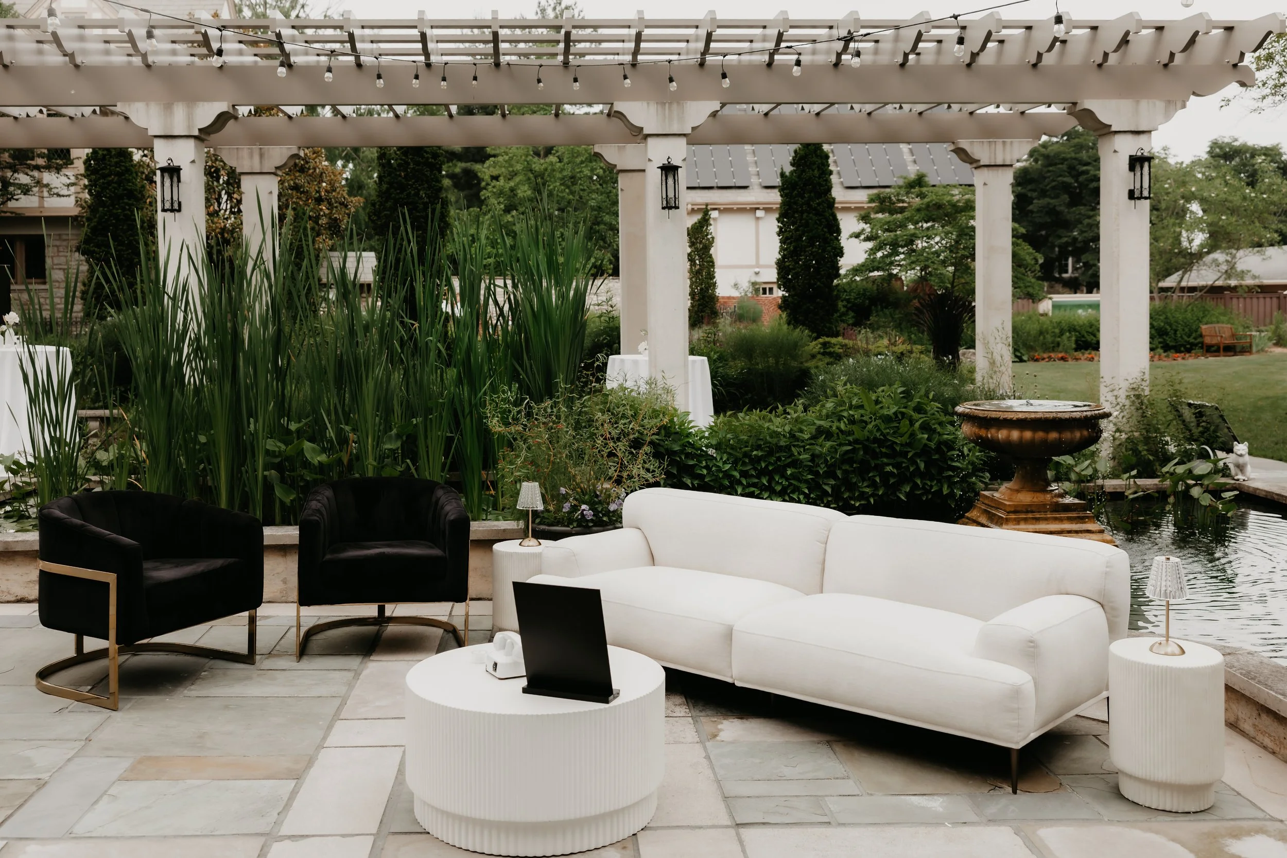 Black-and-white wedding lounge seating overlooking the reflecting pool and gardens at the Ohio Governor’s Residence, photographed by Julia Brown Photo.