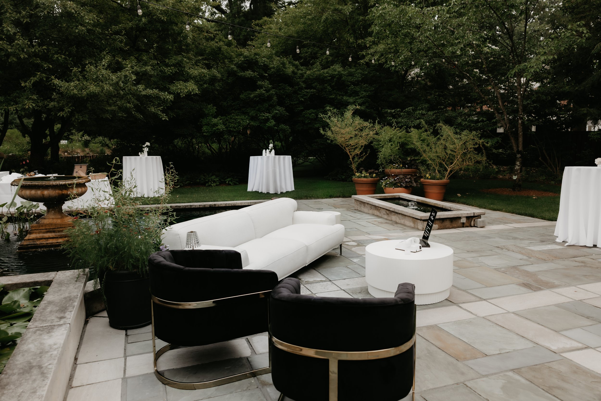 Modern black-and-white cocktail lounge arranged outdoors beside the gardens at the Ohio Governor’s Residence, photographed by Julia Brown Photo.