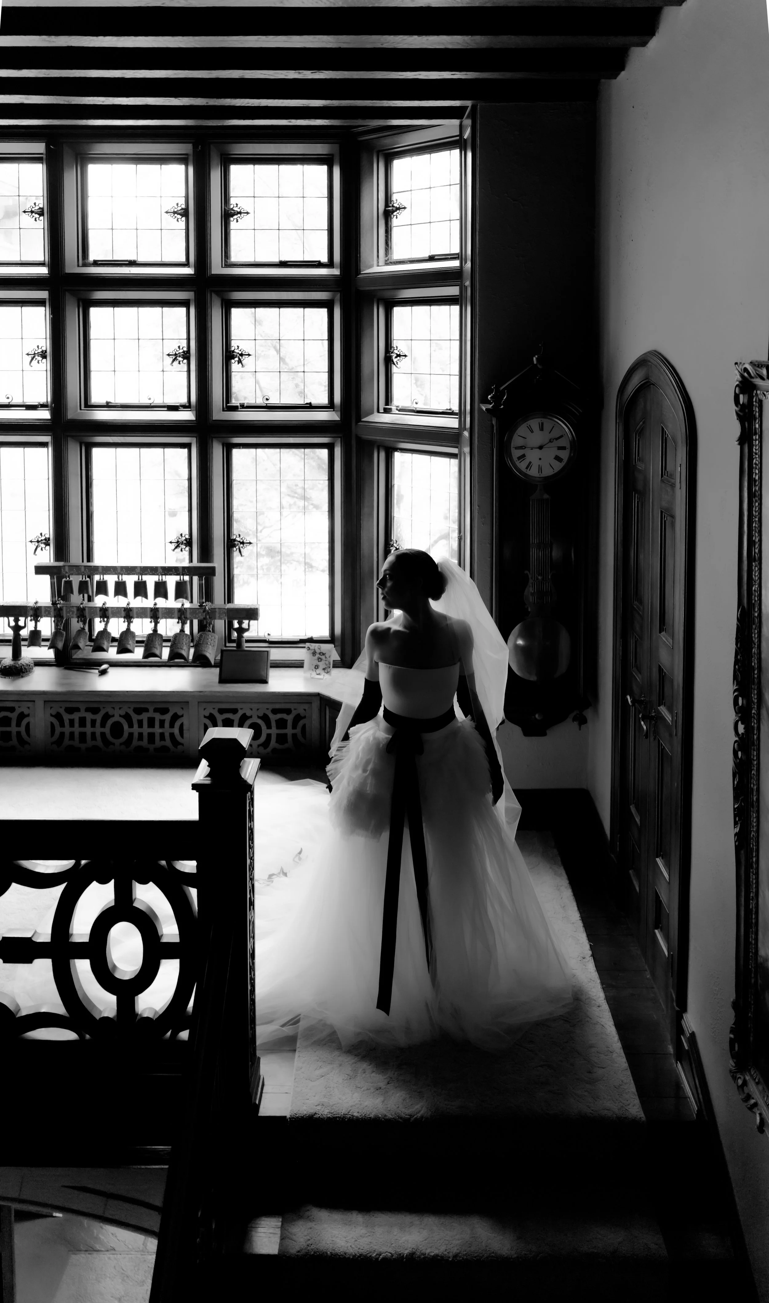 Black-and-white wedding portrait of the bride and groom beside historic windows inside the Ohio Governor’s Residence, photographed by Julia Brown Photo.