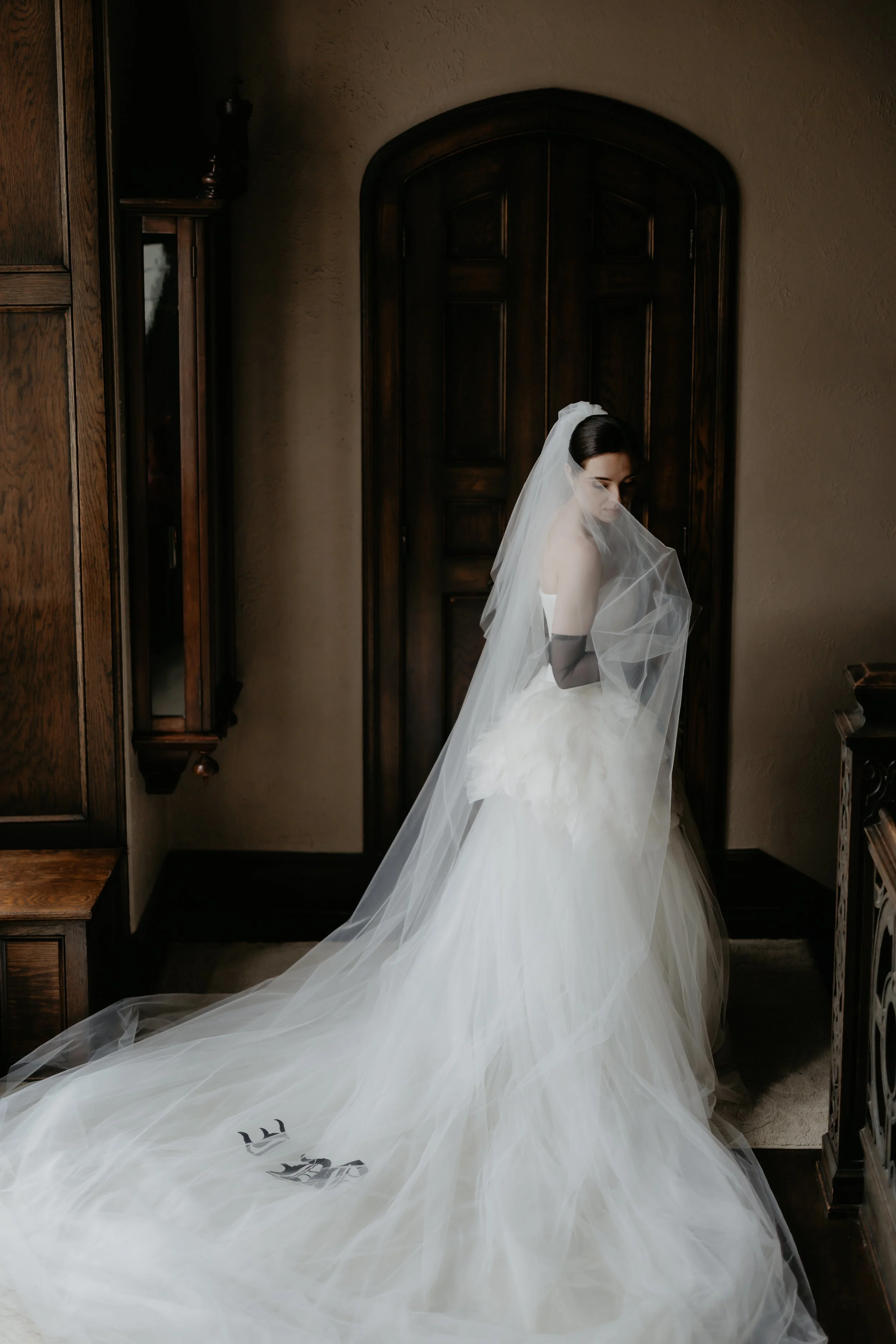 Editorial bridal portrait featuring a Vera Wang wedding gown and long veil inside the historic Ohio Governor’s Residence, photographed by Julia Brown Photo.