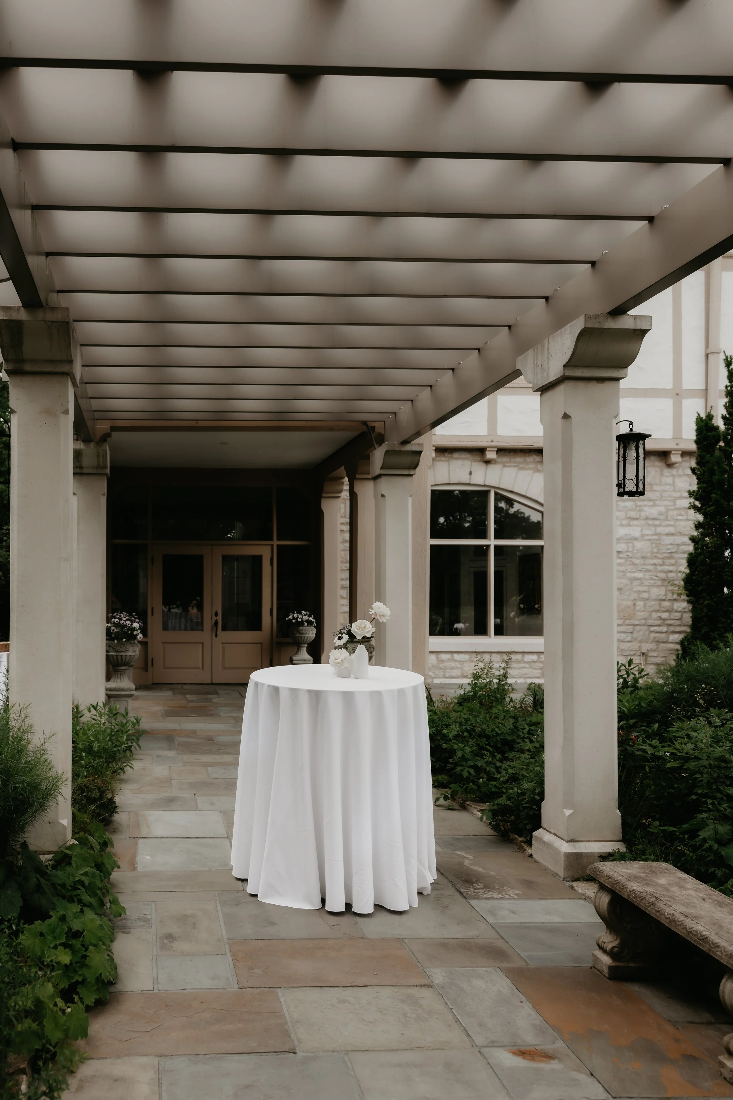 Cocktail table beneath a covered garden walkway at the Ohio Governor’s Residence and Heritage Garden, photographed by Julia Brown Photo.
