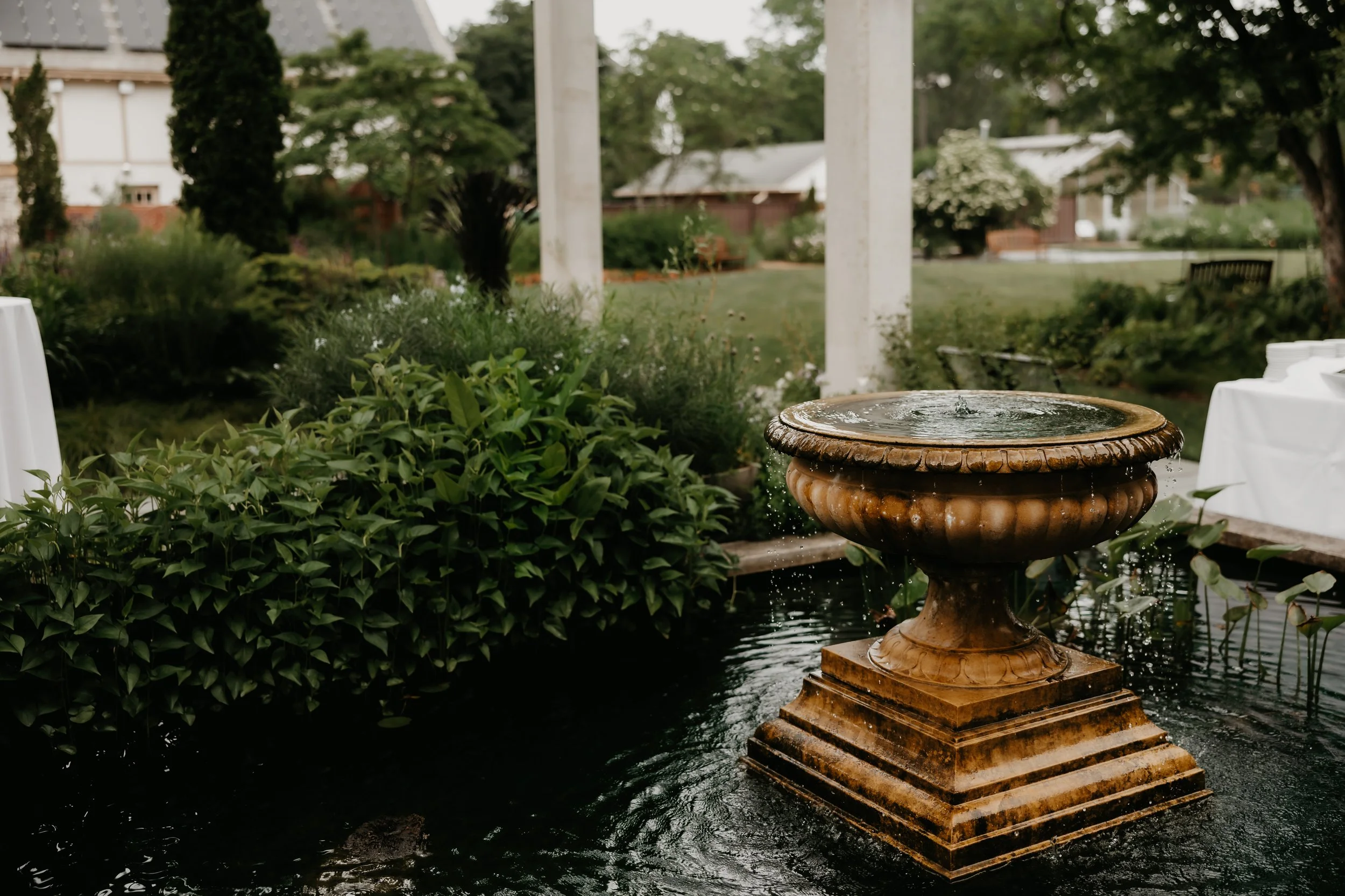 Decorative fountain surrounded by water and greenery in the Heritage Garden in Bexley, Ohio, photographed by Julia Brown Photo.