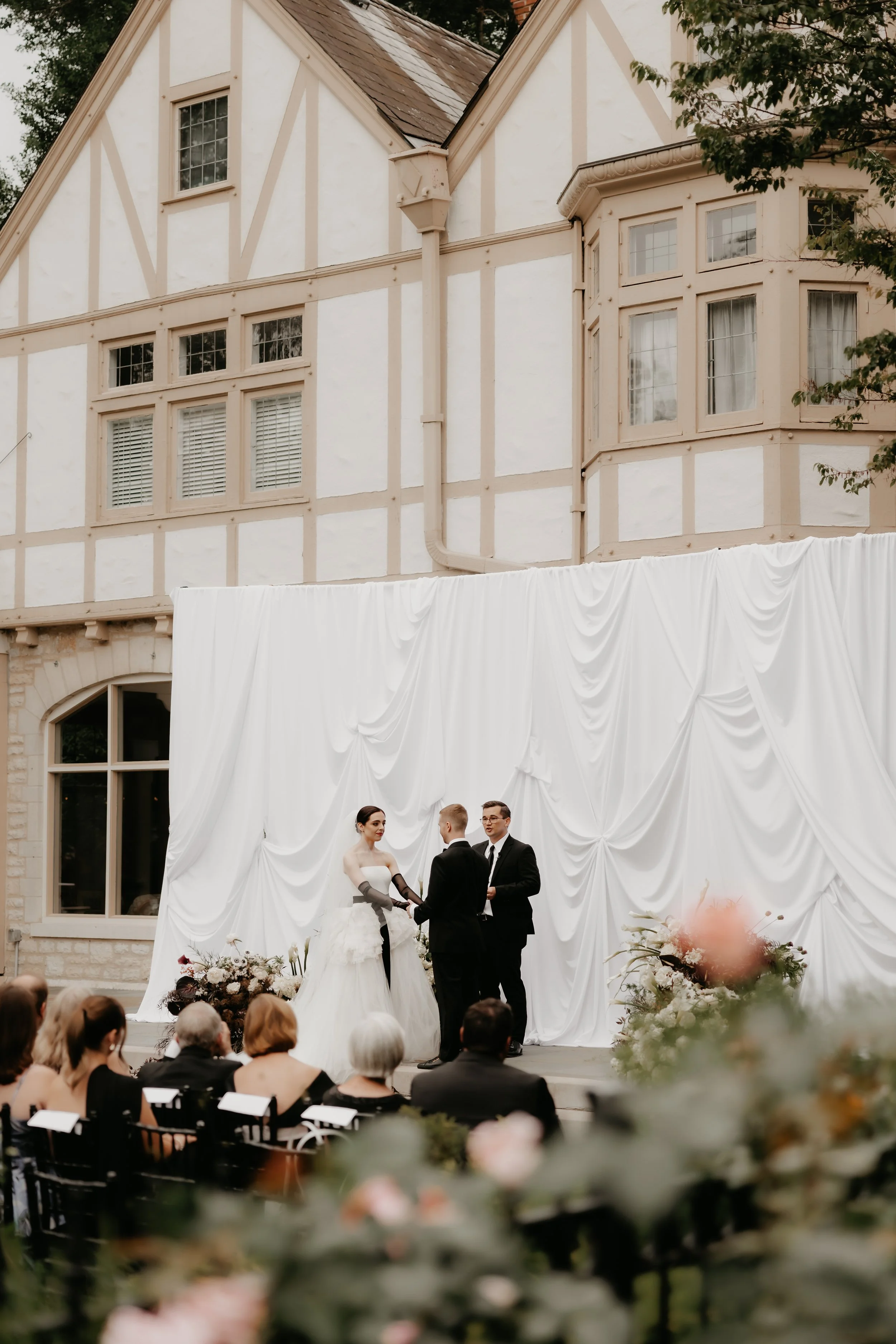 Outdoor wedding ceremony framed by the historic architecture of the Ohio Governor’s Residence in Bexley, Ohio, photographed by Julia Brown Photo.