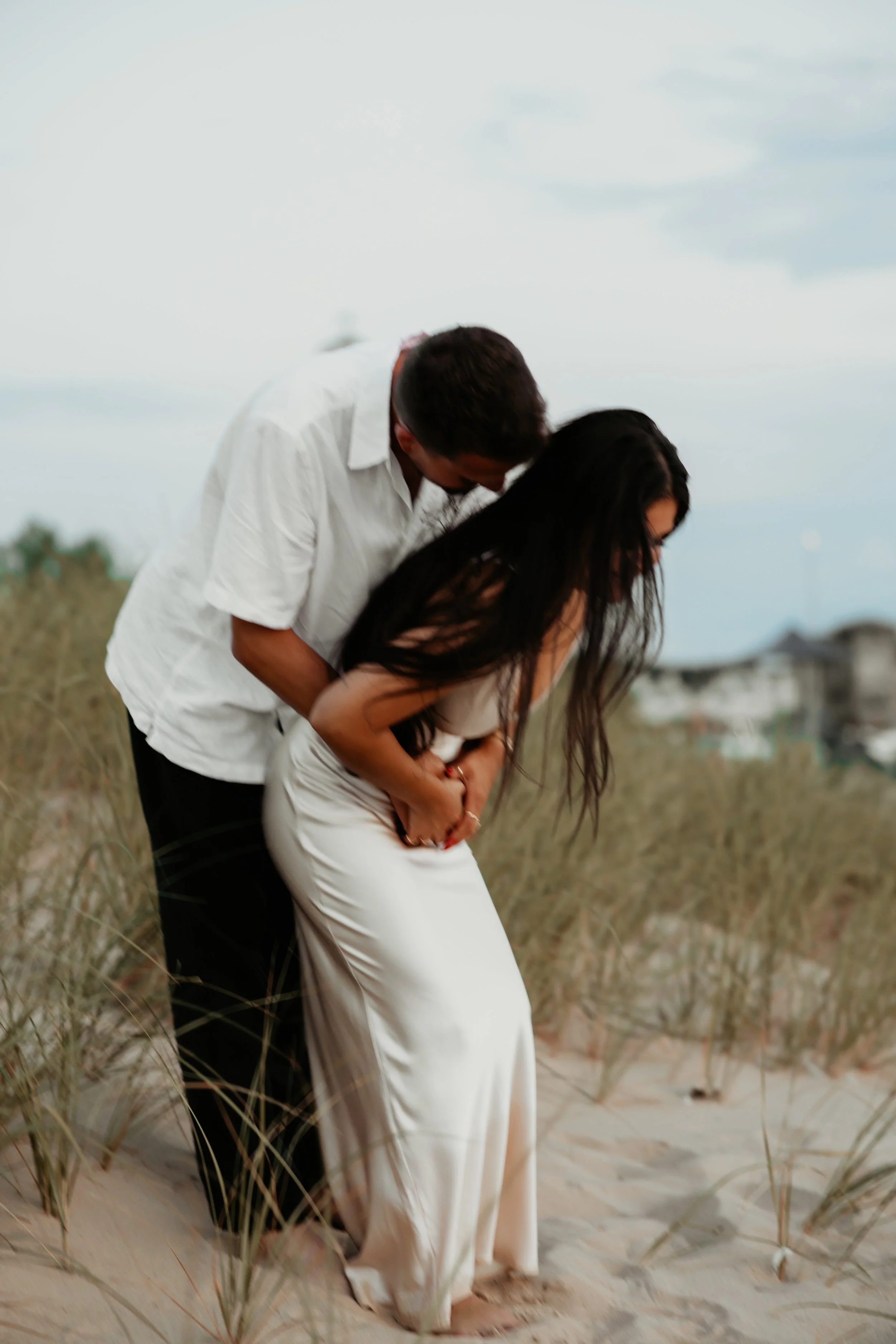 Playful Engagement Photos in the Grand Beach Dunes