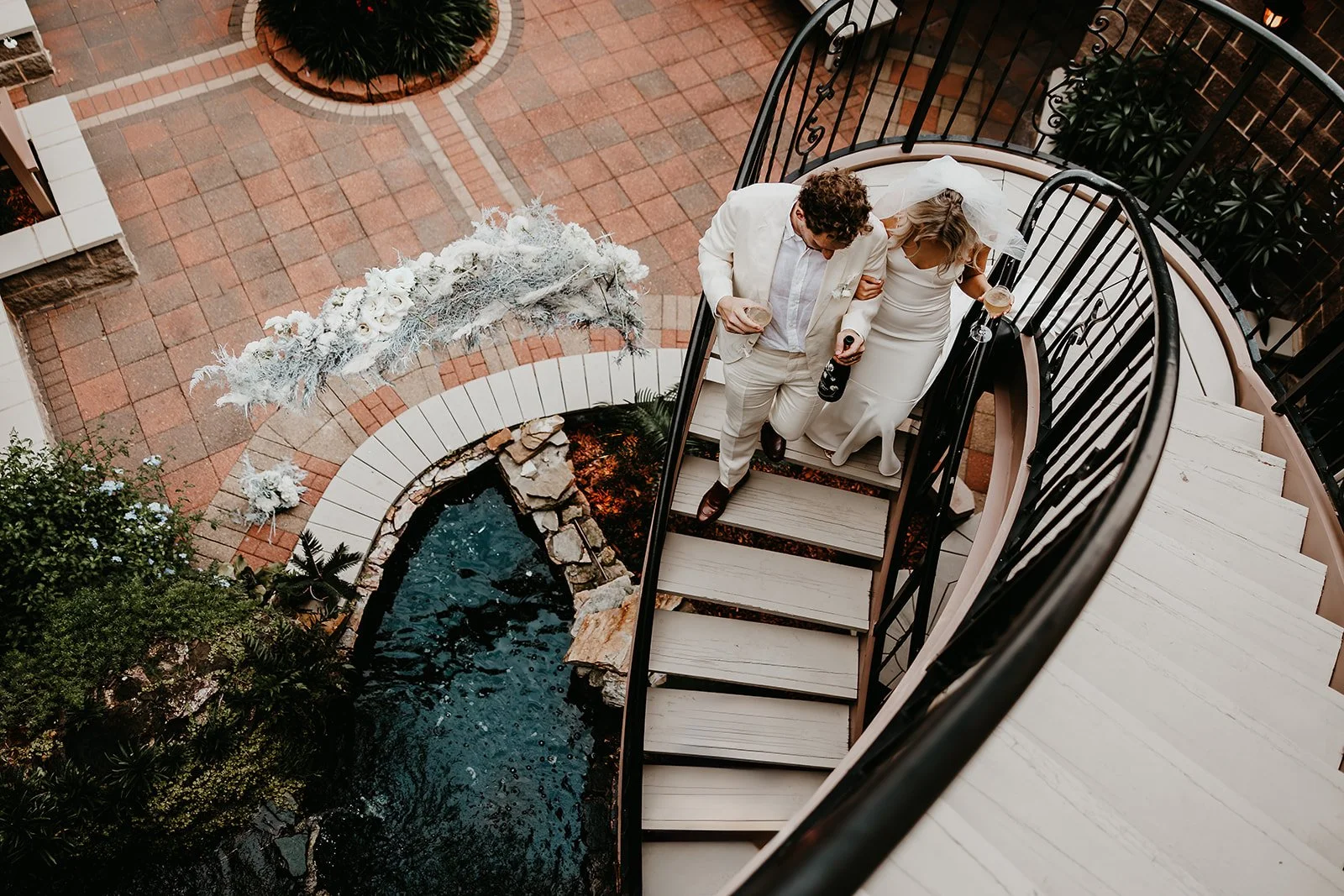 Galveston-Texas-Destination-Wedding-Bride-Groom-Descending-Stairs-Julia-Brown-Photo..jpg