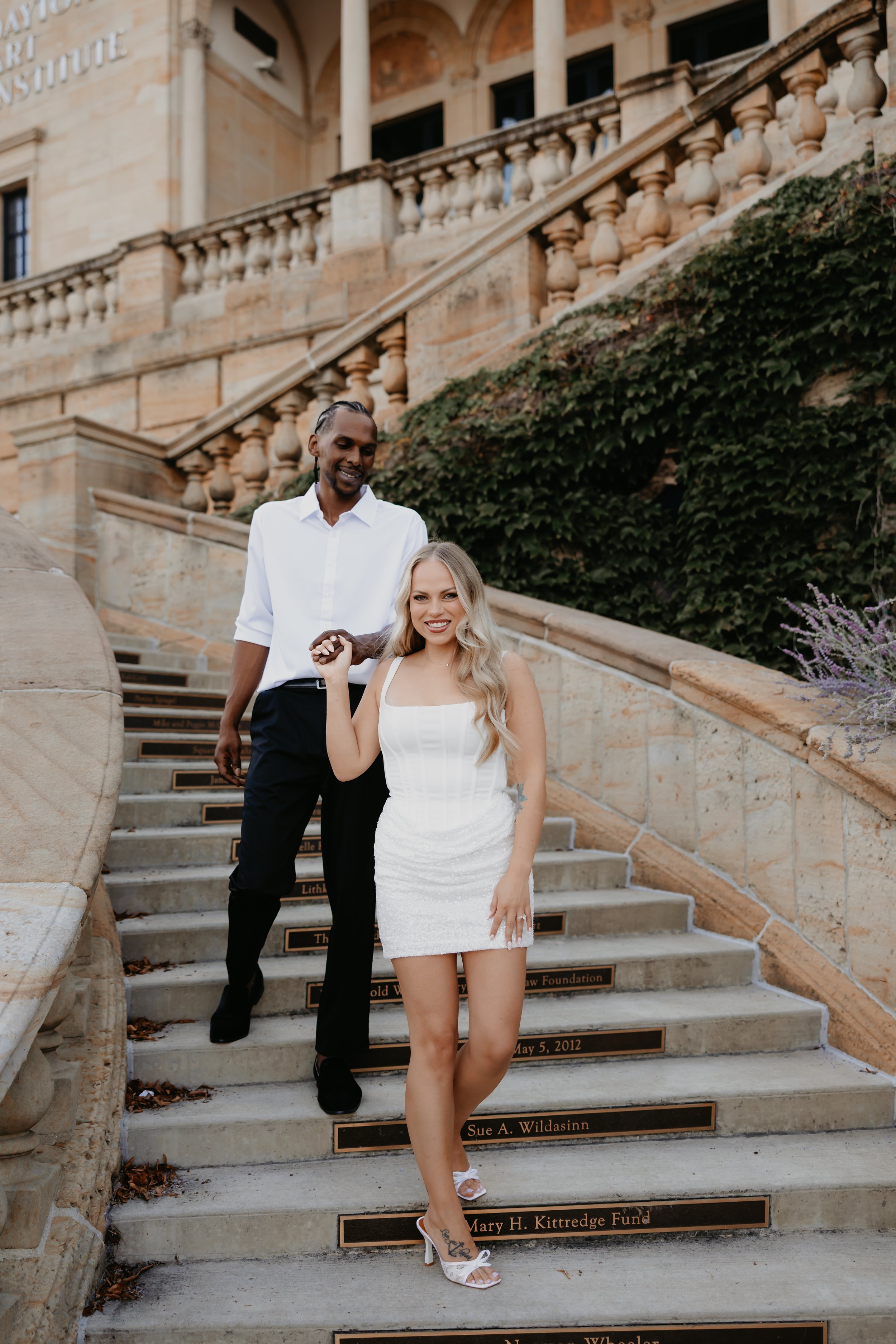 Candid Engagement Photos on Outdoor Grand Spiral Staircase