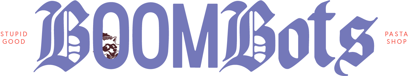 The image displays the text 'BOOMBOTS' in large gothic-style purple font. Small red text on the left reads 'STUPID GOOD' and on the right 'PASTAS SHOP'.