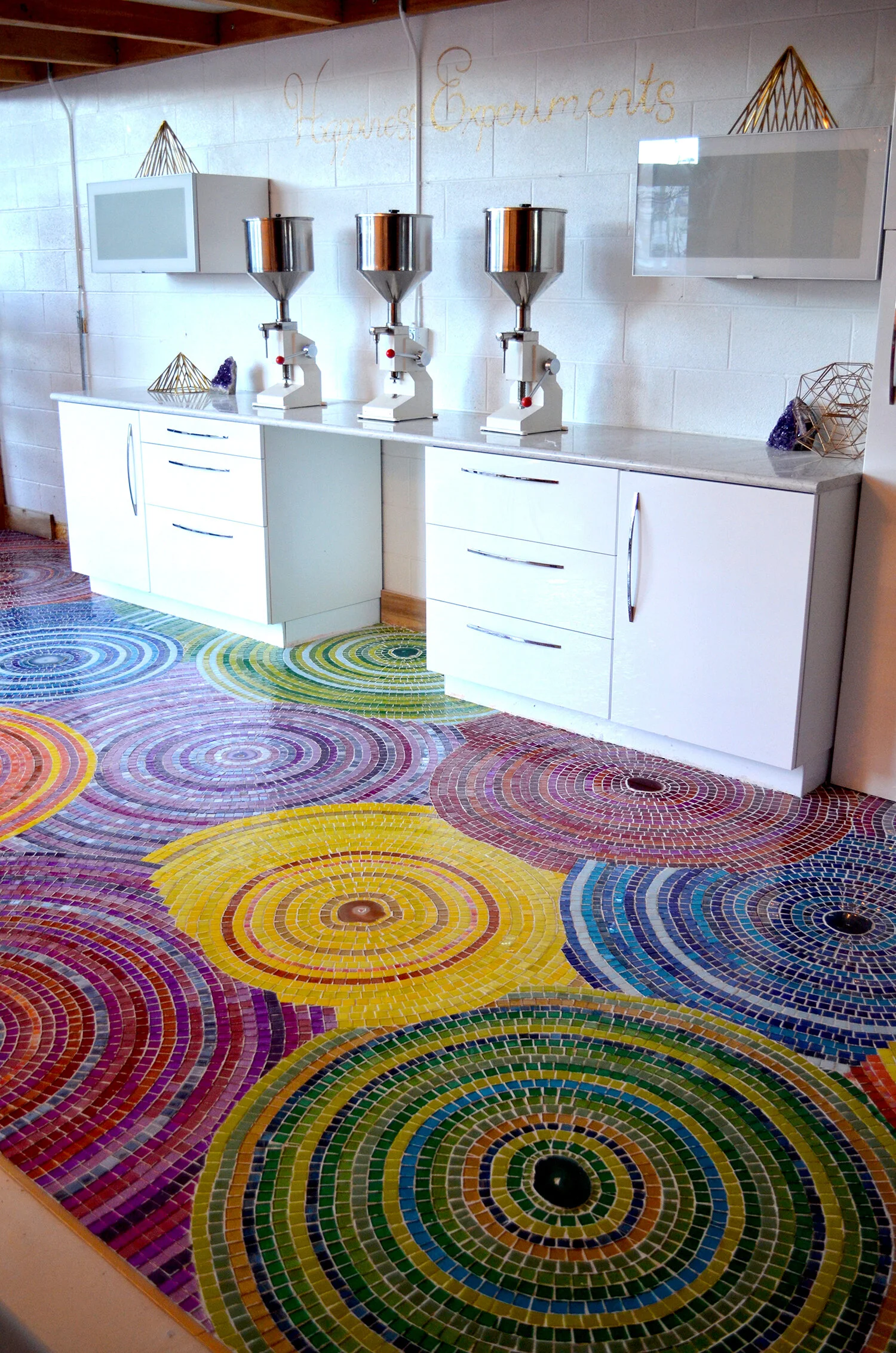 Custom mosaic rainbow and glitter floor installation with agate crystals by Denver artist Emily Dwan