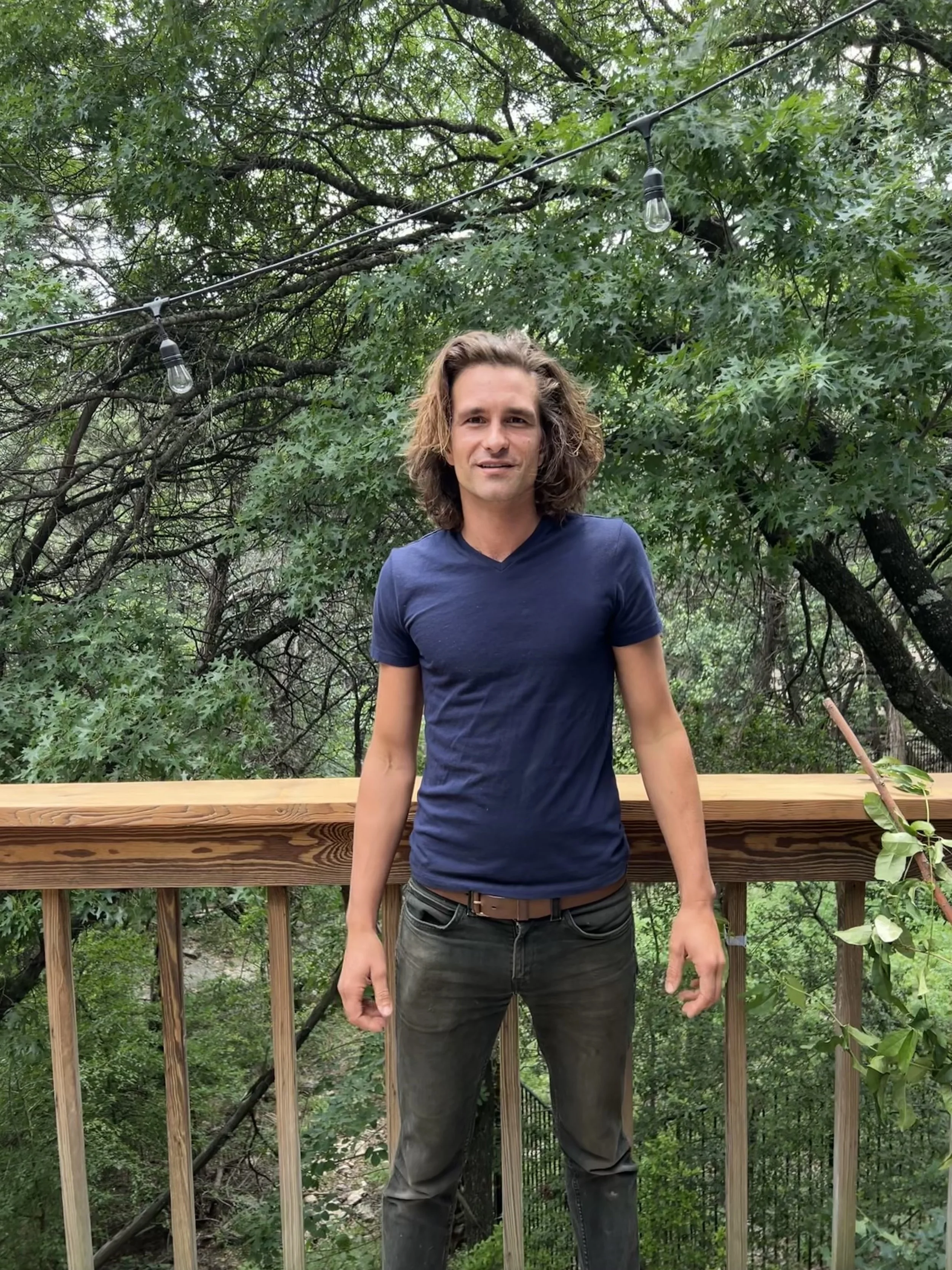 Exterior view of a custom sauna and deck by Hot Bird Saunas, set among trees with natural wood details and outdoor gathering space. Founder of Hot Bird Saunas.