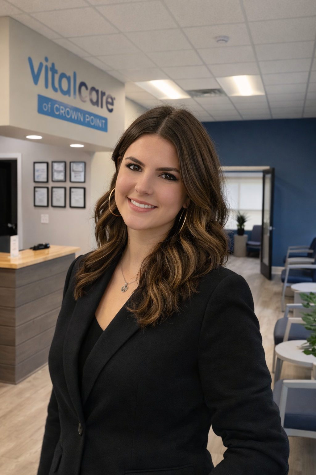 A woman with long, wavy, reddish-brown hair taking a selfie indoors. She has a nose piercing, tattoos on her arm, and is wearing a black shirt, layered necklaces including a cross, and a smartwatch on her wrist. The image has a caption labeled "Saturday 5:34 PM."
