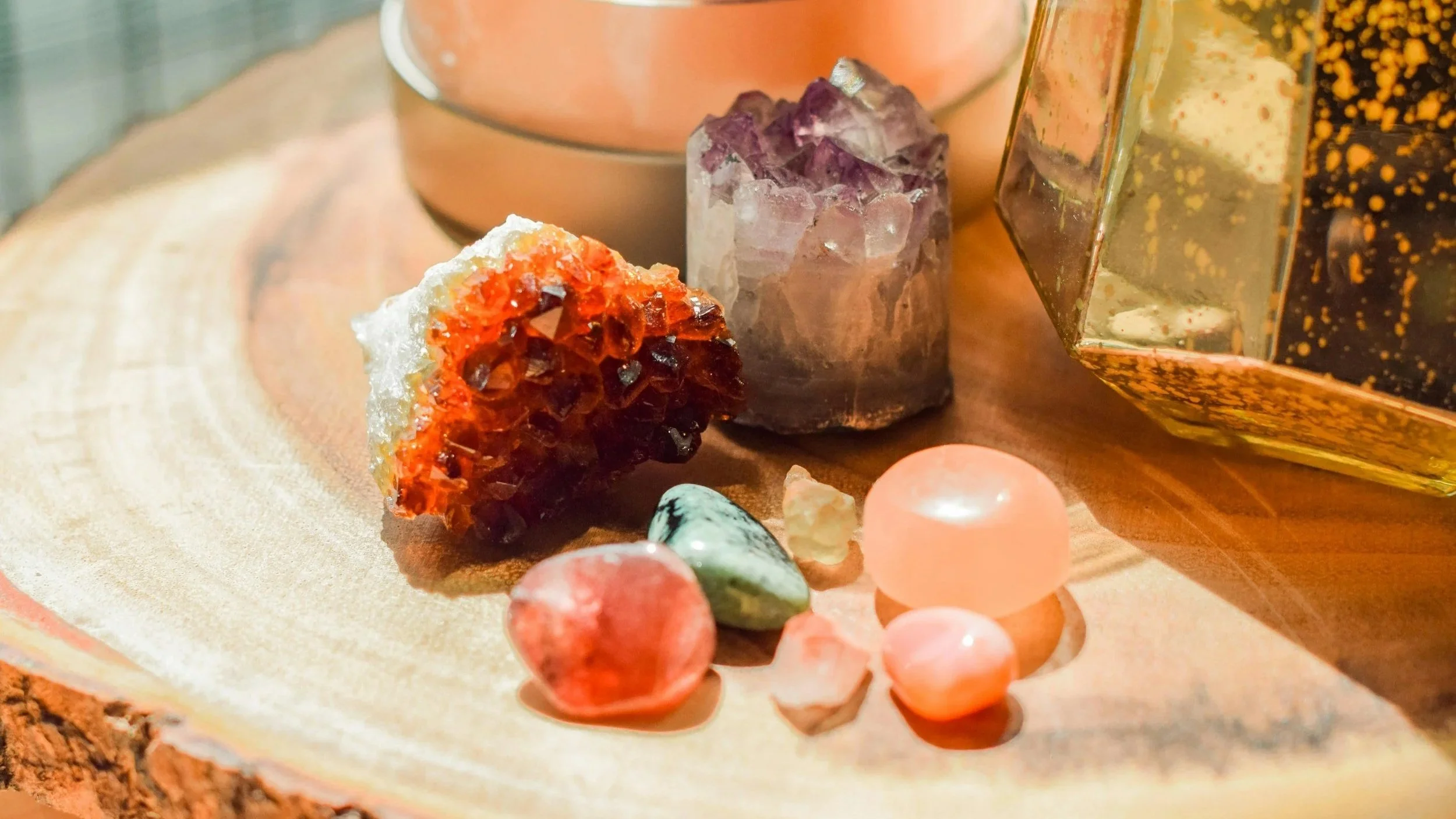 A collection of colourful crystals and stones arranged on a table.