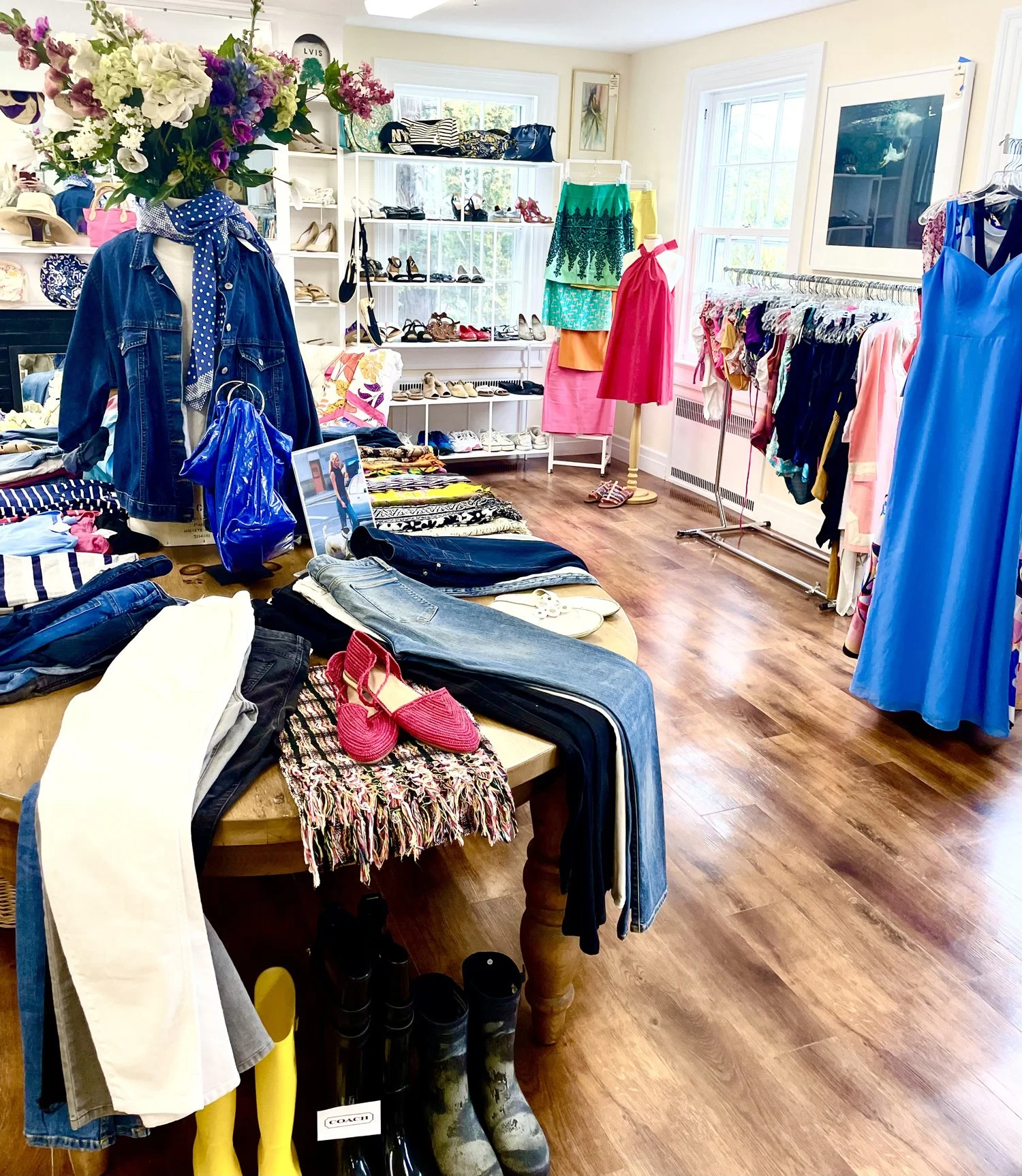 LVIS thrift Shops manequin wearing a bright green summer dress with pink and yellowfloral pattern
