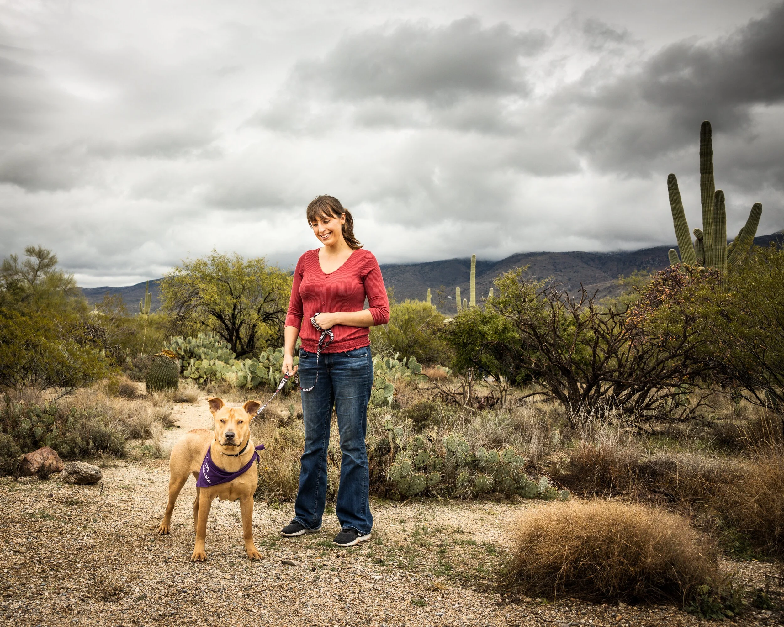 A portrait of a woman and dog at Saguaro National Park East in Tucson, AZ.