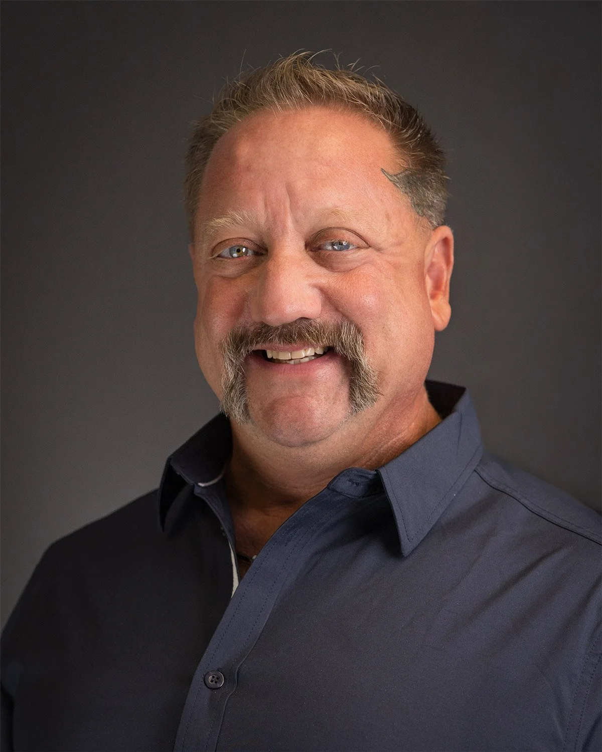 Headshot portrait of a man with mustache.jpg