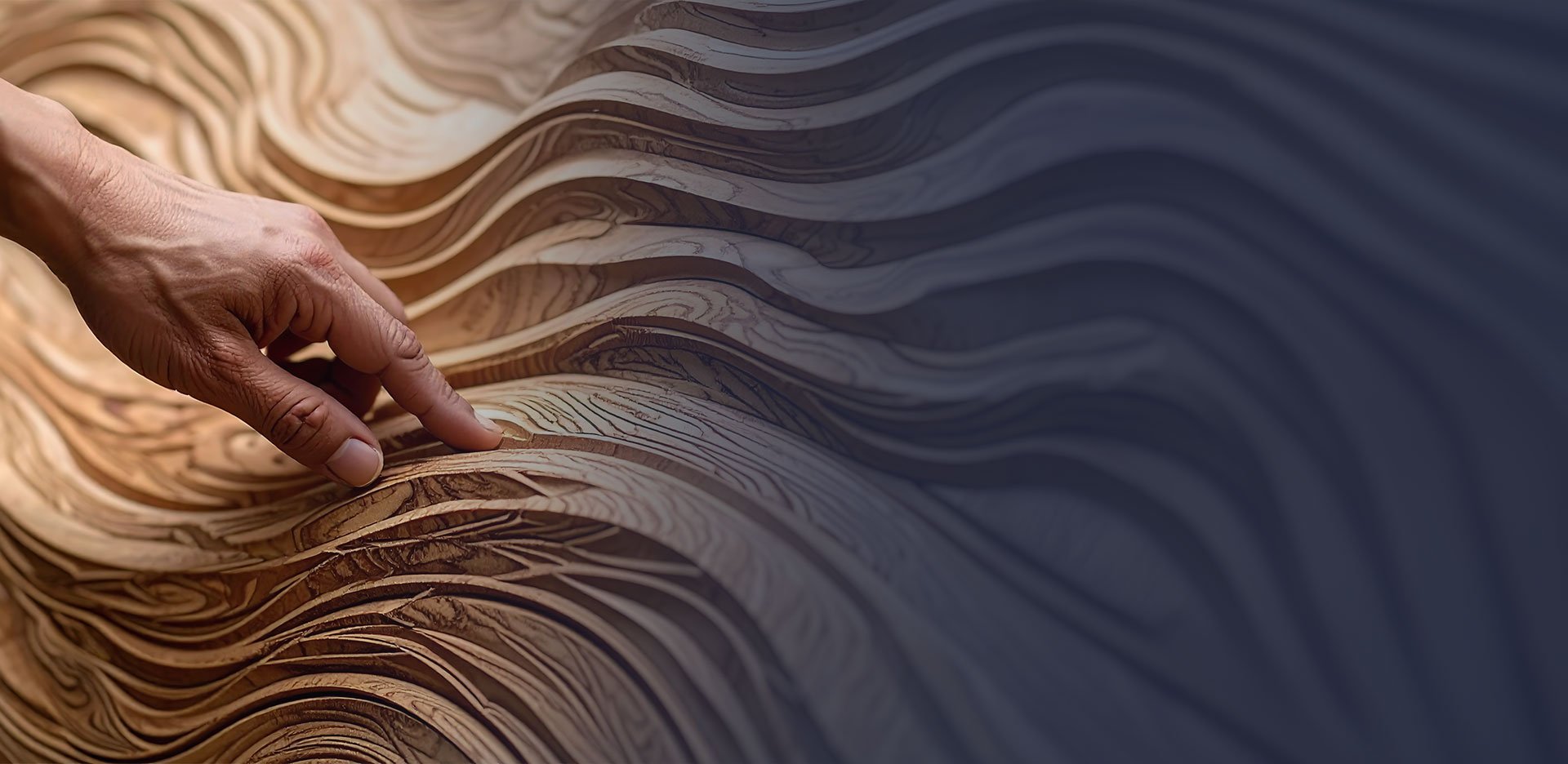 A hand touching layered wooden sheets with intricate grain patterns and smooth curves.