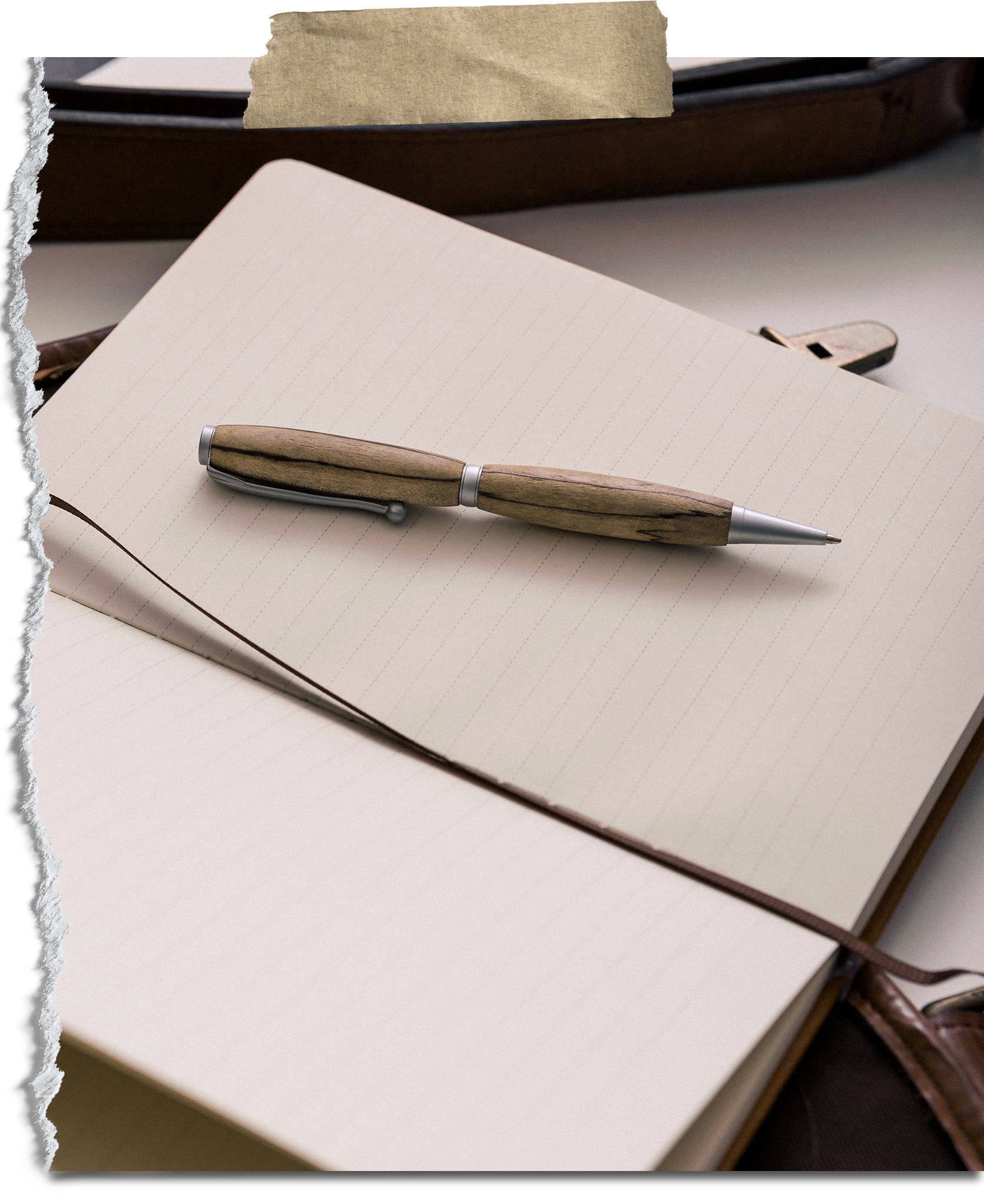 An open notebook with lined pages, a pen with a wooden handle resting on it, and a brown leather bag in the background.