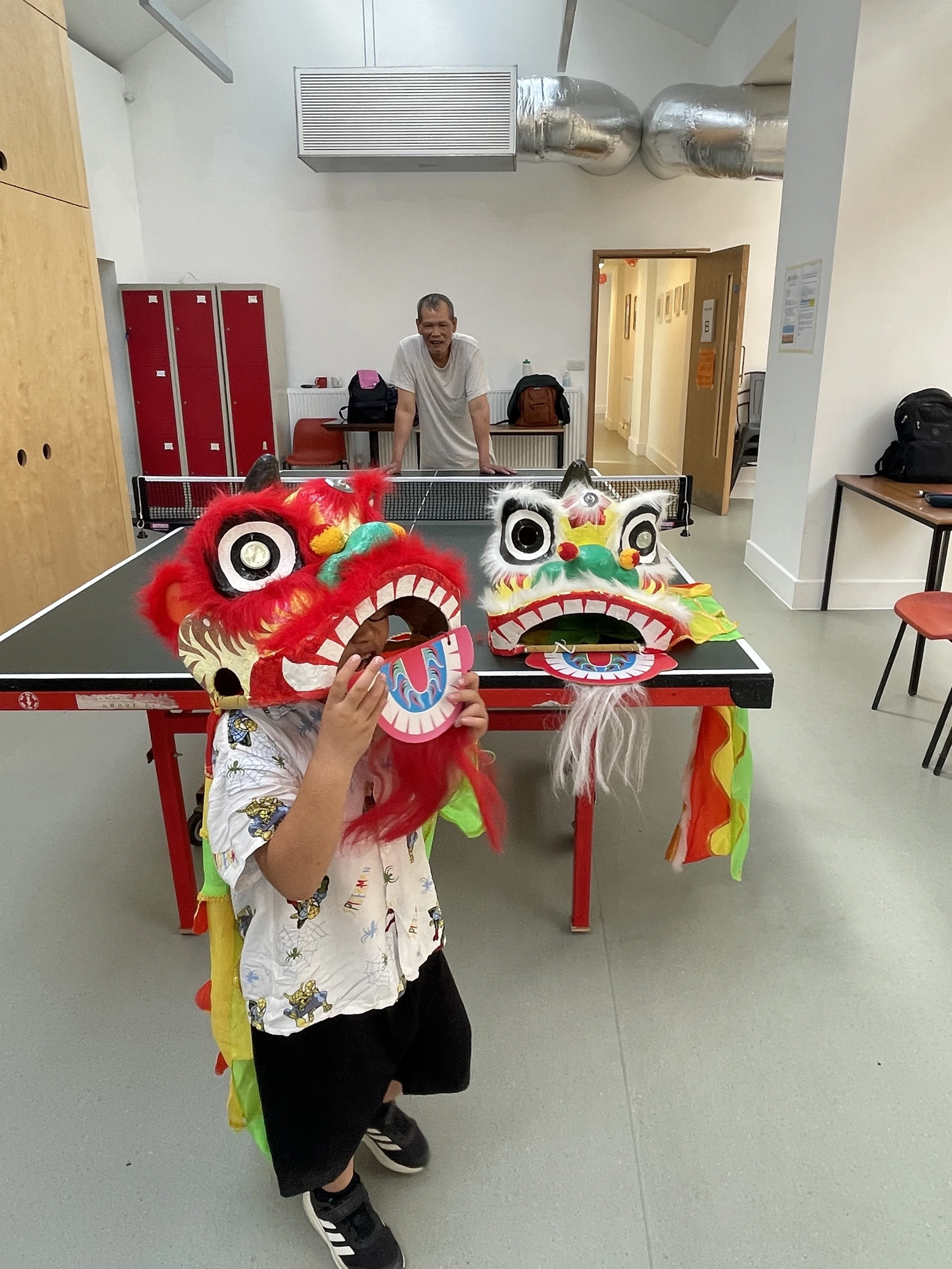 Photo of a child playing with Lion Dance gear for children.
