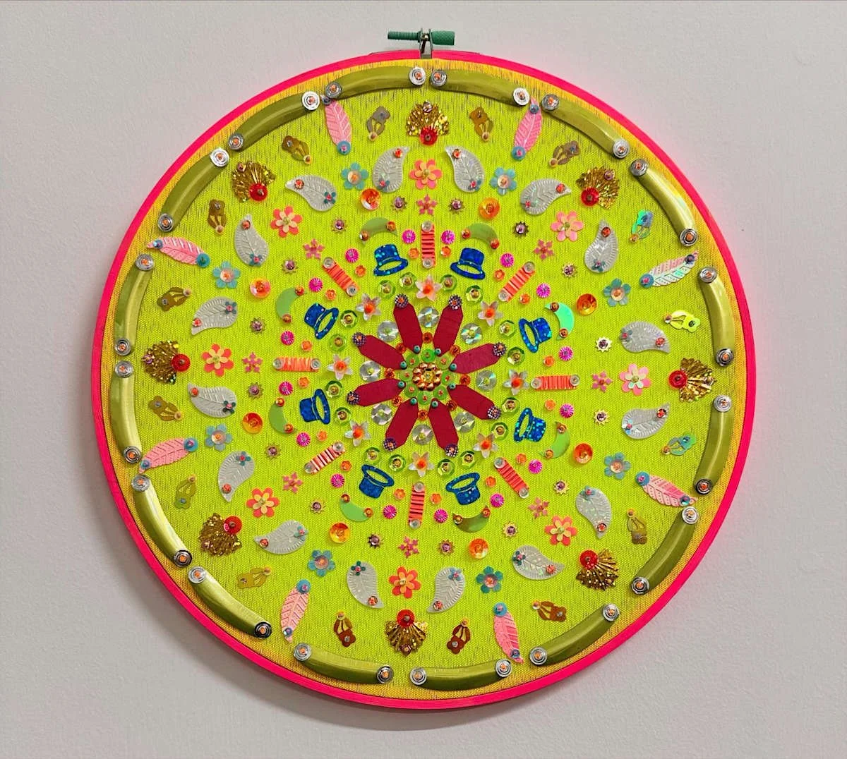 Colorful decorative wall clock with various ornament designs on a lime green background.