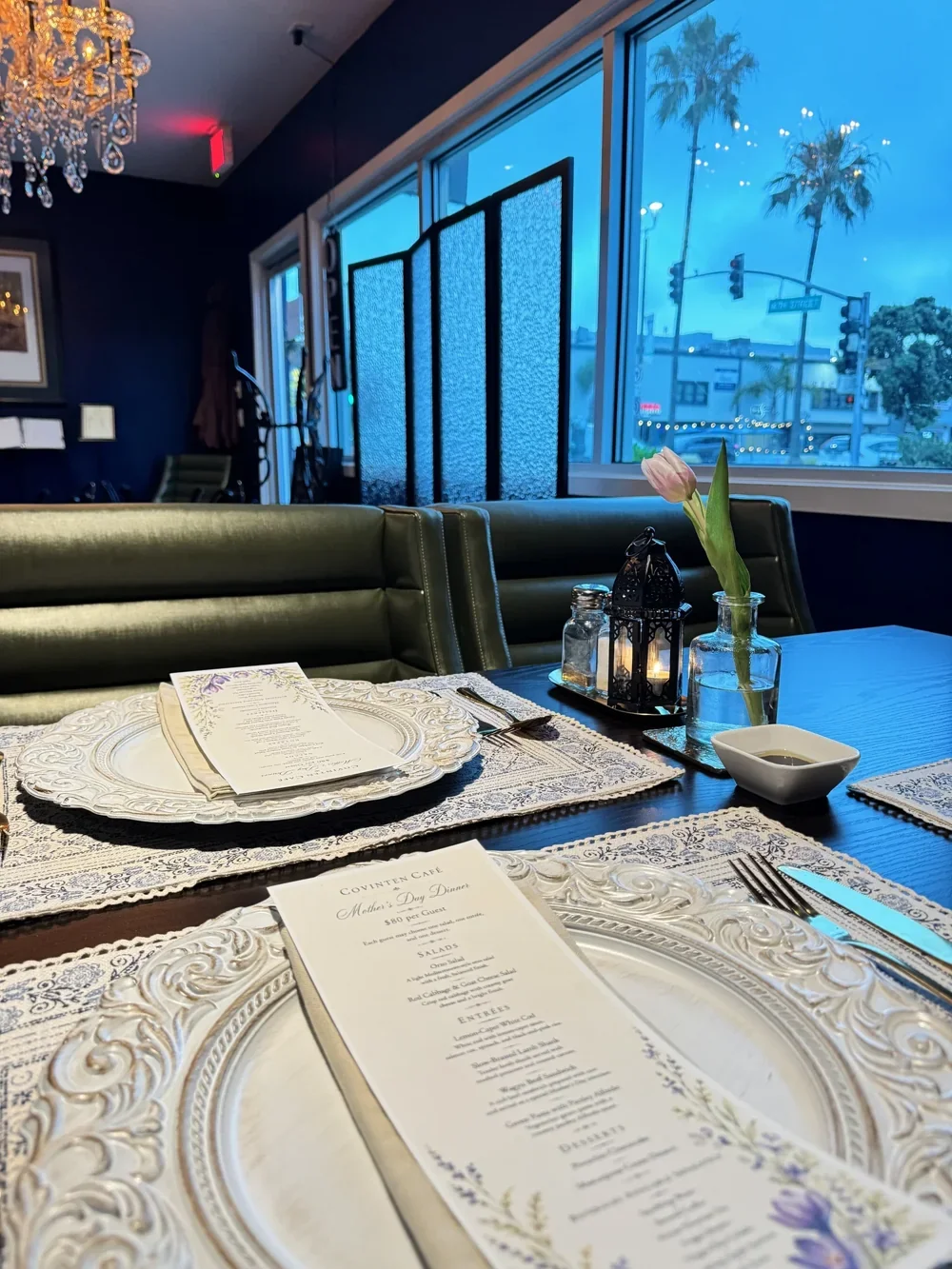 A table set for dinner beside the windows at Covinten