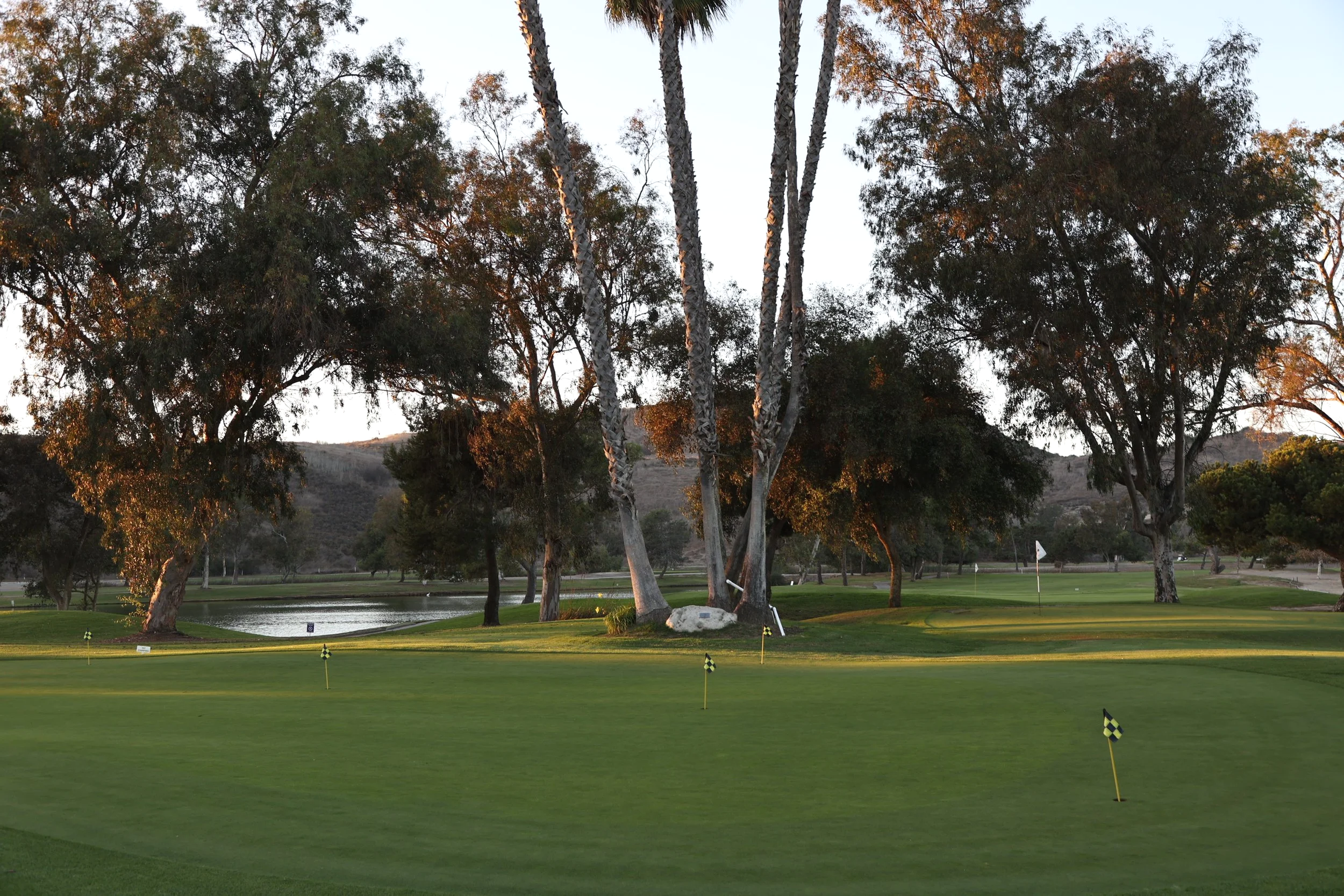 Oceanside Golf Course practice green and lake at dusk