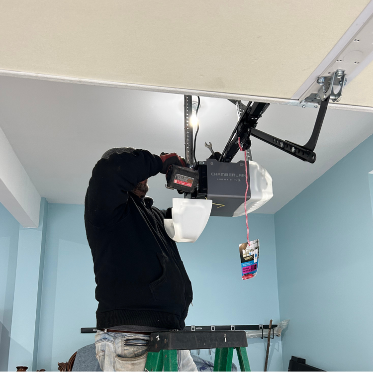 Garage door workers performing installation or repair