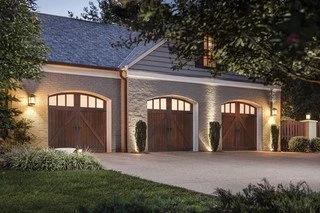 A three-car garage with arched wooden doors, Manufacturer-provided garage door style reference for residential garage door installation and replacement inspiration in Northern Virginia. Final availability, specifications, pricing, and installation sc
