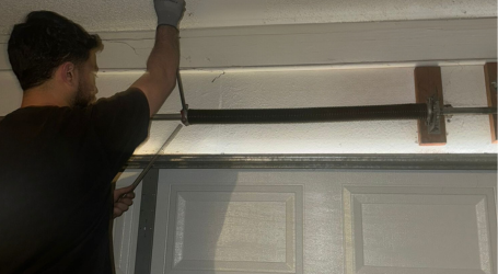 Garage door repair being performed by workers