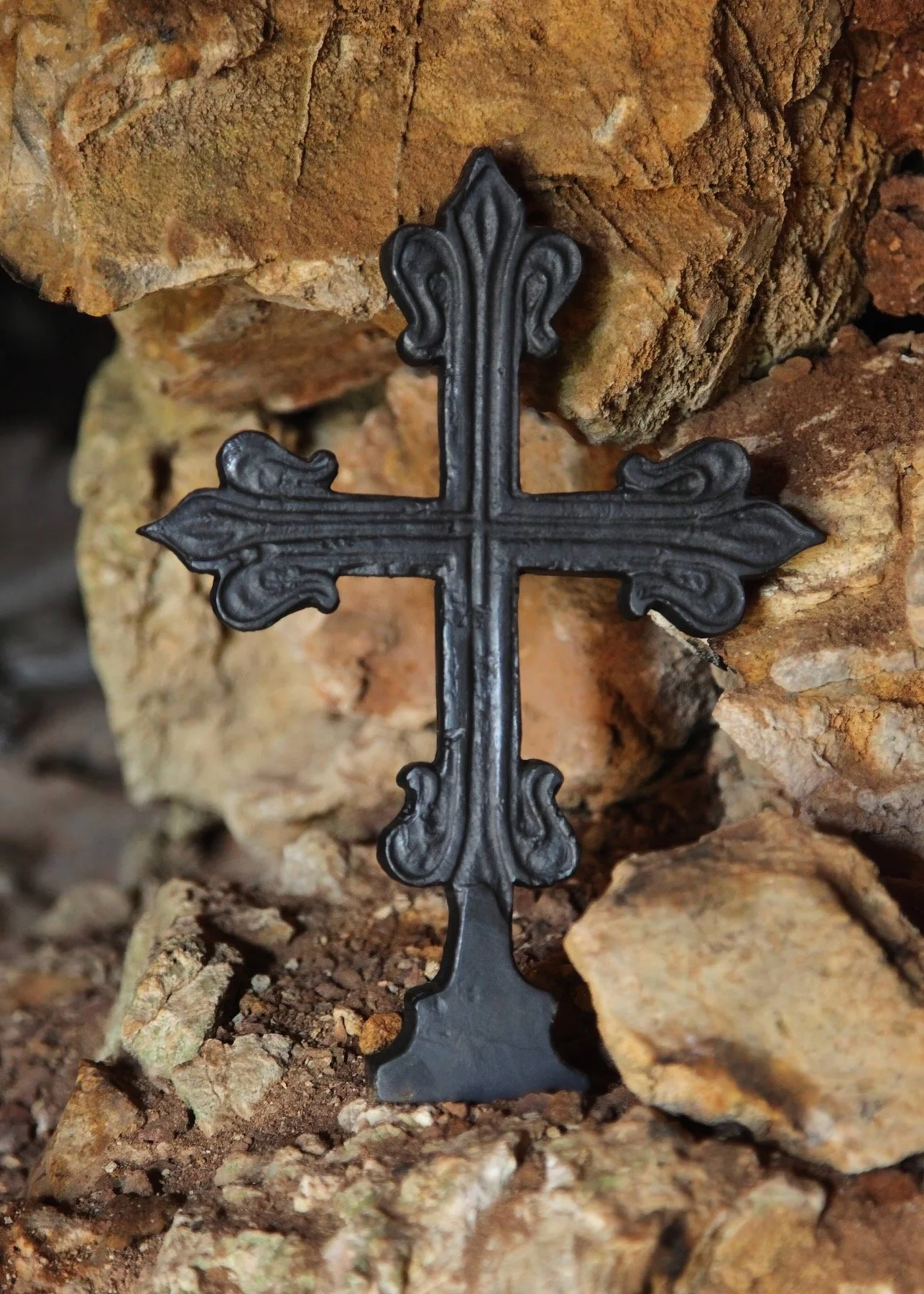 Metal Cross on Stones.jpeg