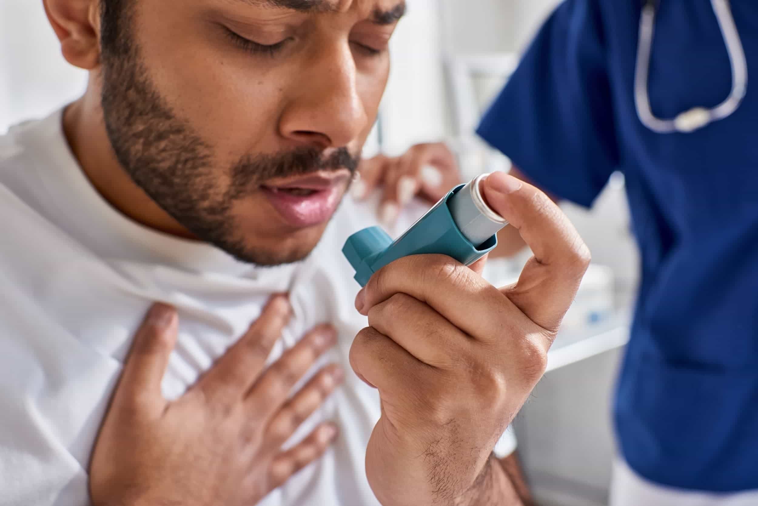A man using an asthma pump.