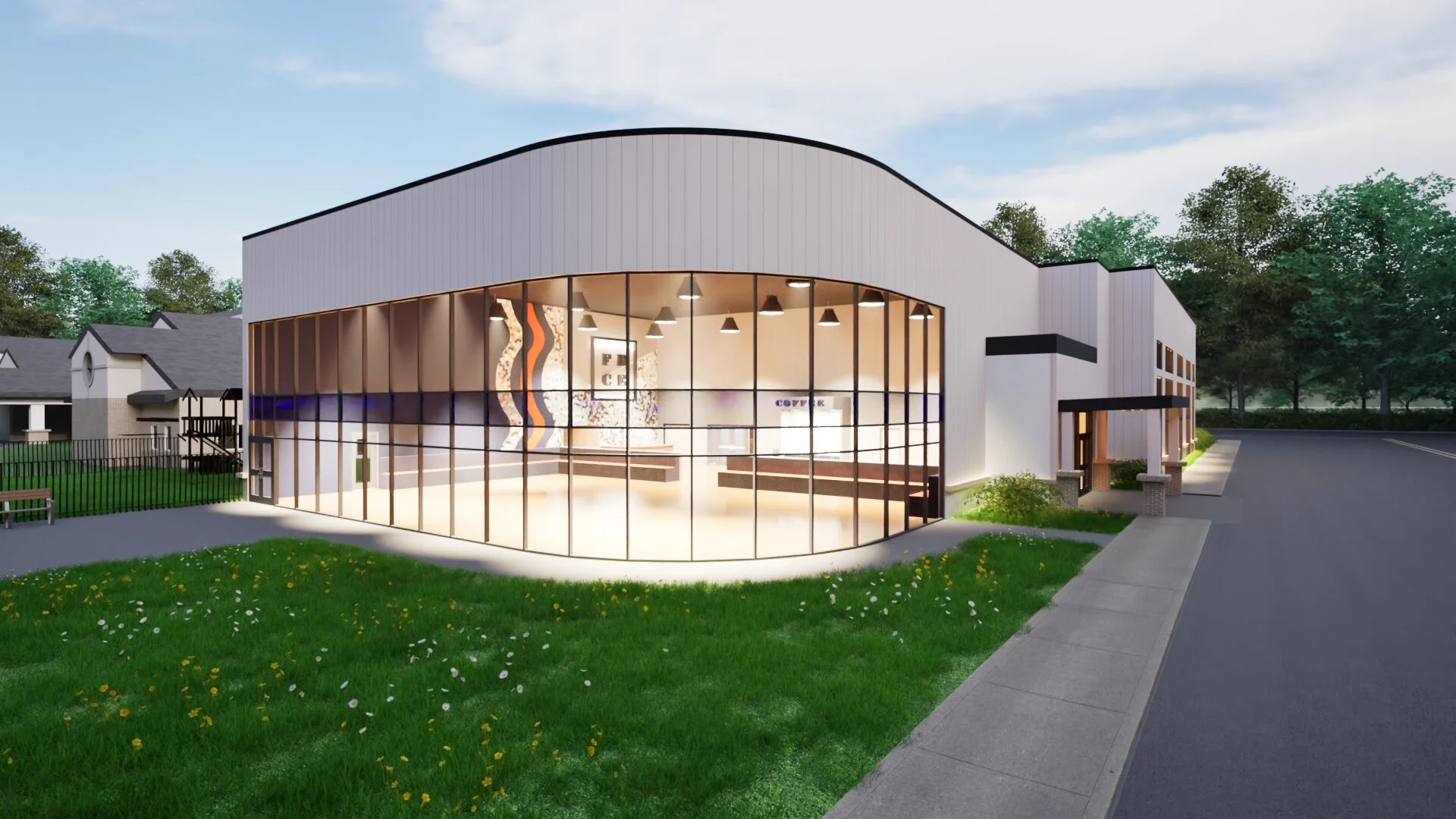 A modern coffee shop with a large glass front and white exterior, surrounded by a sidewalk, grassy lawn, and trees in the background.