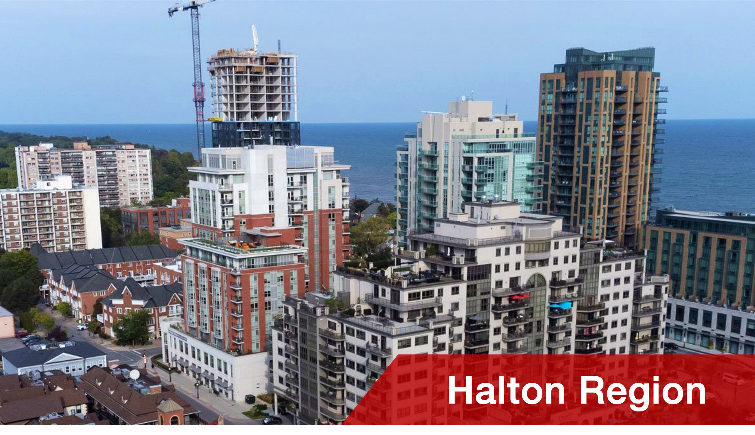 A cityscape of high-rise buildings with the ocean in the background, showing development in a bustling city, with the text 'Halton Region' in a red banner at the bottom.