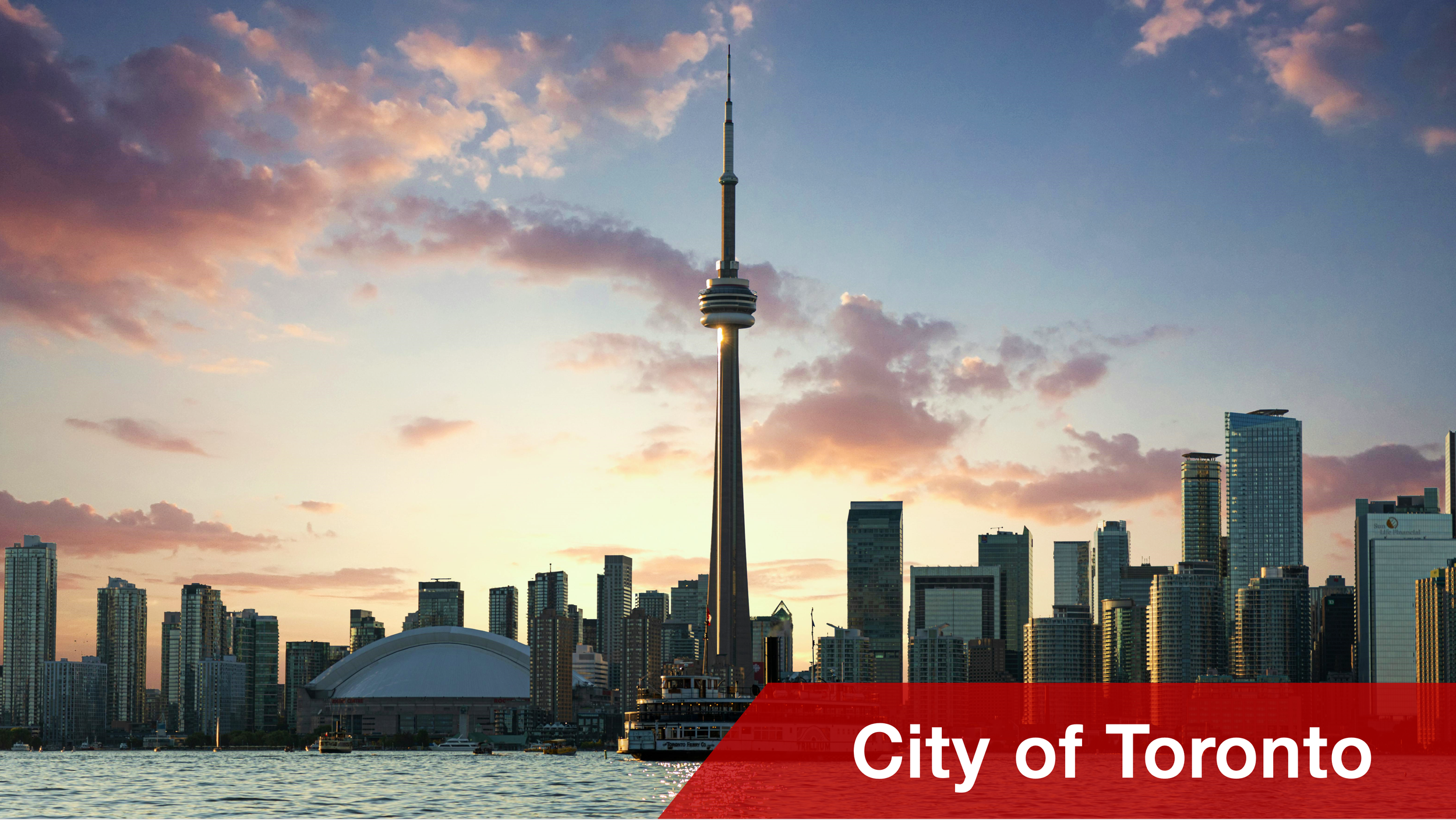 Skyline of Toronto with the CN Tower, high-rise buildings, and a body of water in the foreground during sunset. A boat crosses the water in the foreground, ahead of the text 'City of Toronto' in a red banner at the bottom.