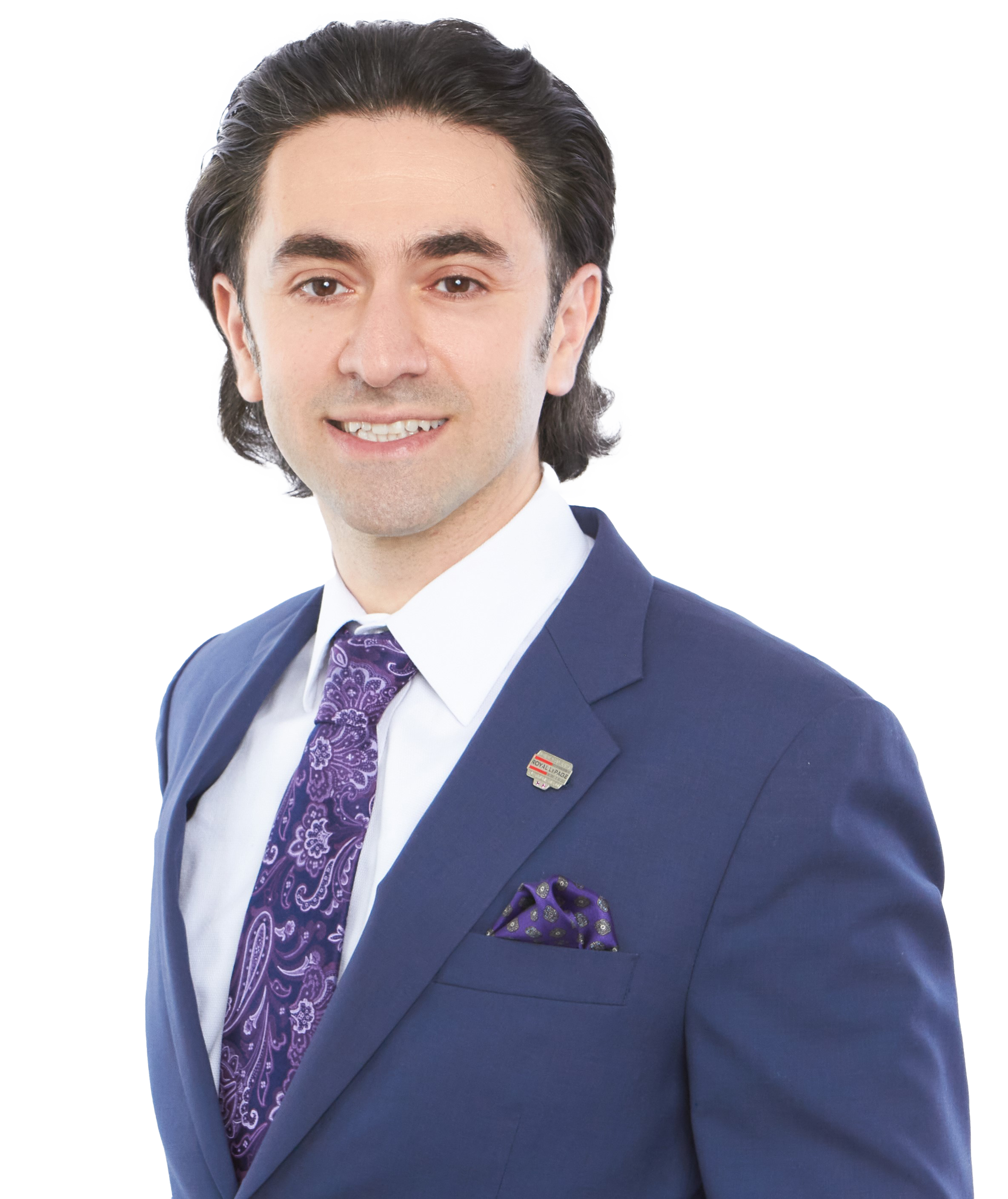 Tom Suleymanov, Simcoe commercial sales and land. Portrait of a man wearing a navy blue suit, white shirt, and purple tie with a matching pocket square, smiling at the camera.