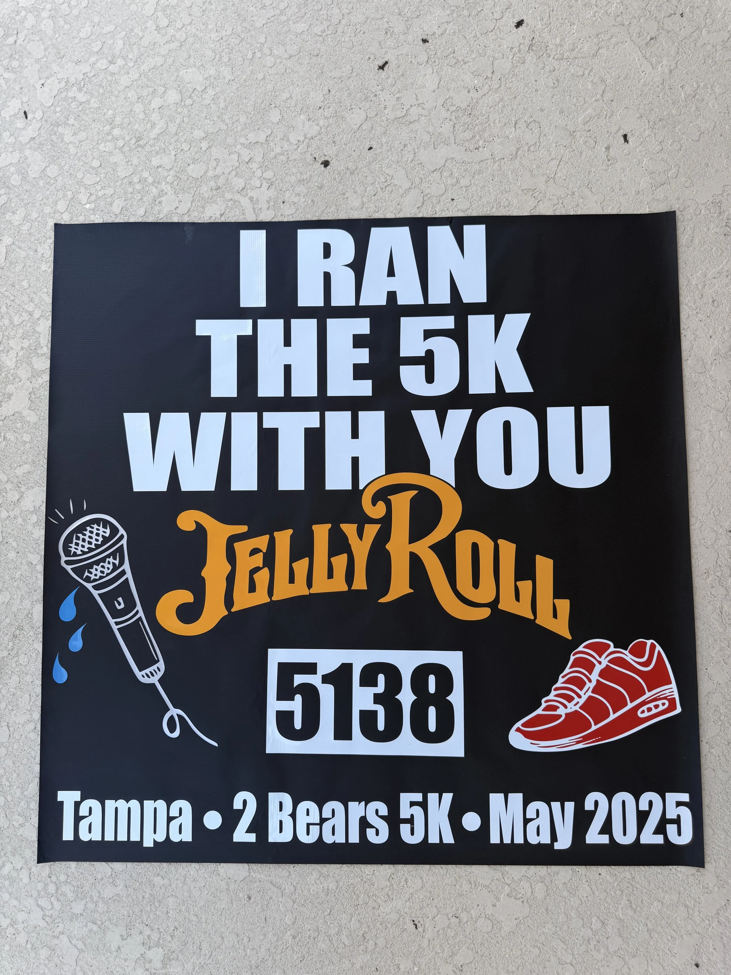 Event poster for a 5K race called 'Jelly Roll' in Tampa, held in May 2025, featuring a microphone and running shoes.