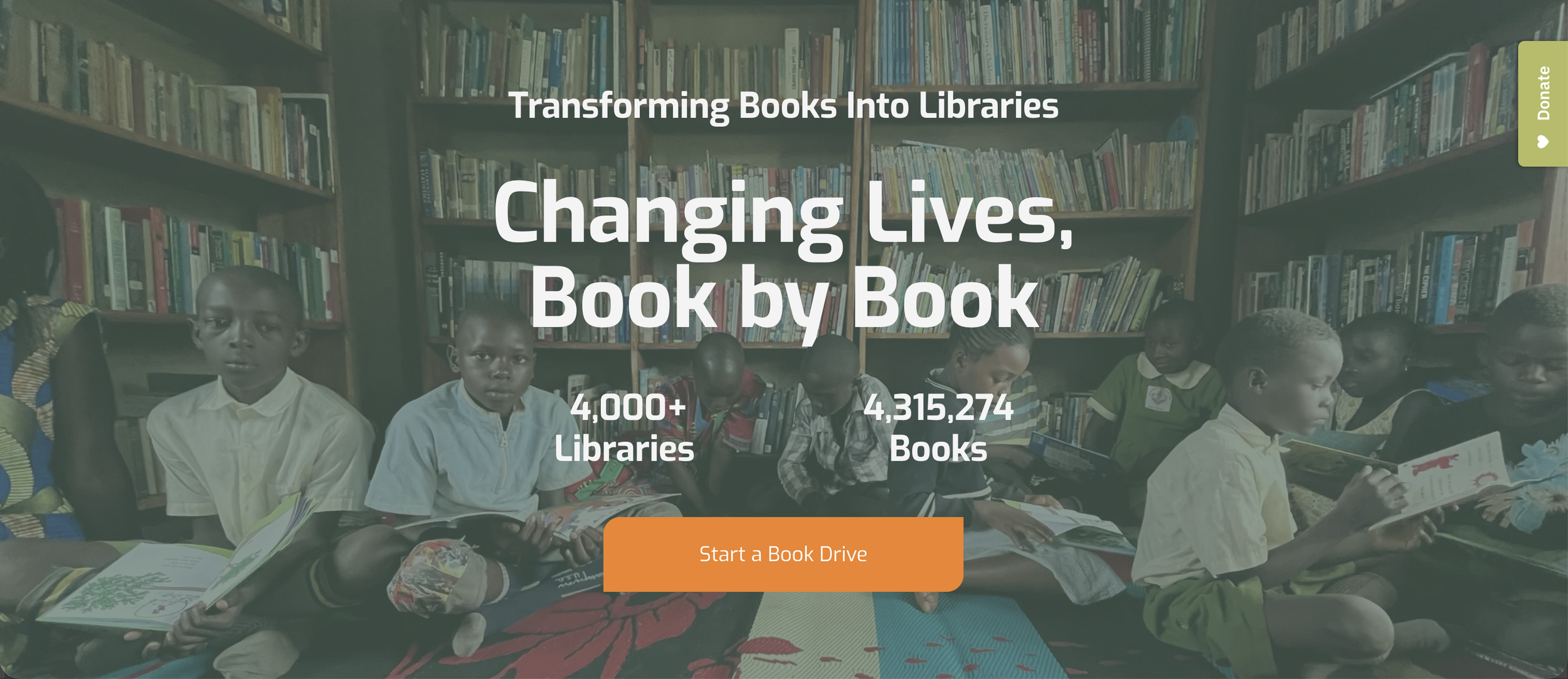 Children sitting in a library reading books.