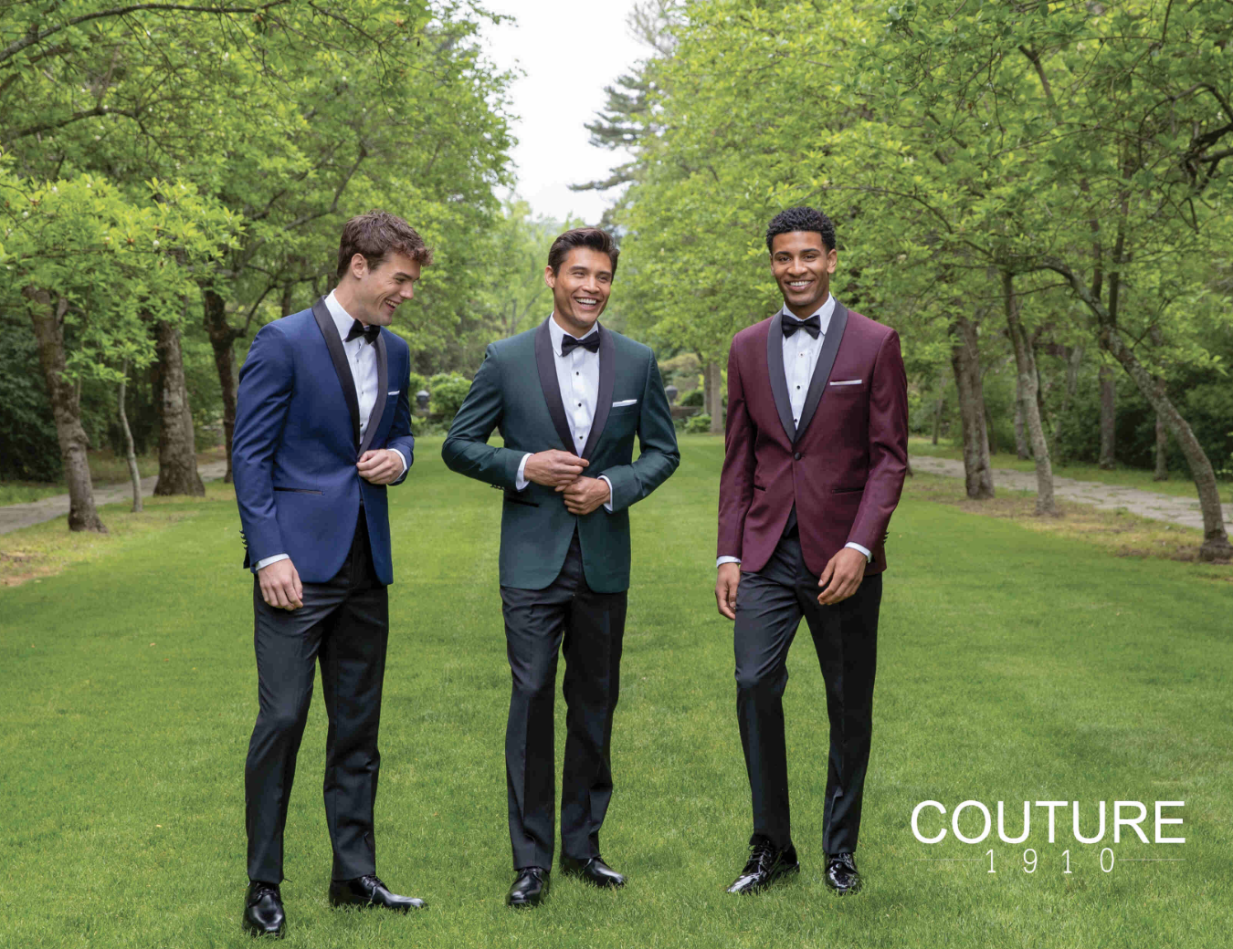 Three men dressed in tuxedos, standing outdoors on a lawn with trees, smiling, with text 'COUTURE 1910' in the lower right corner.