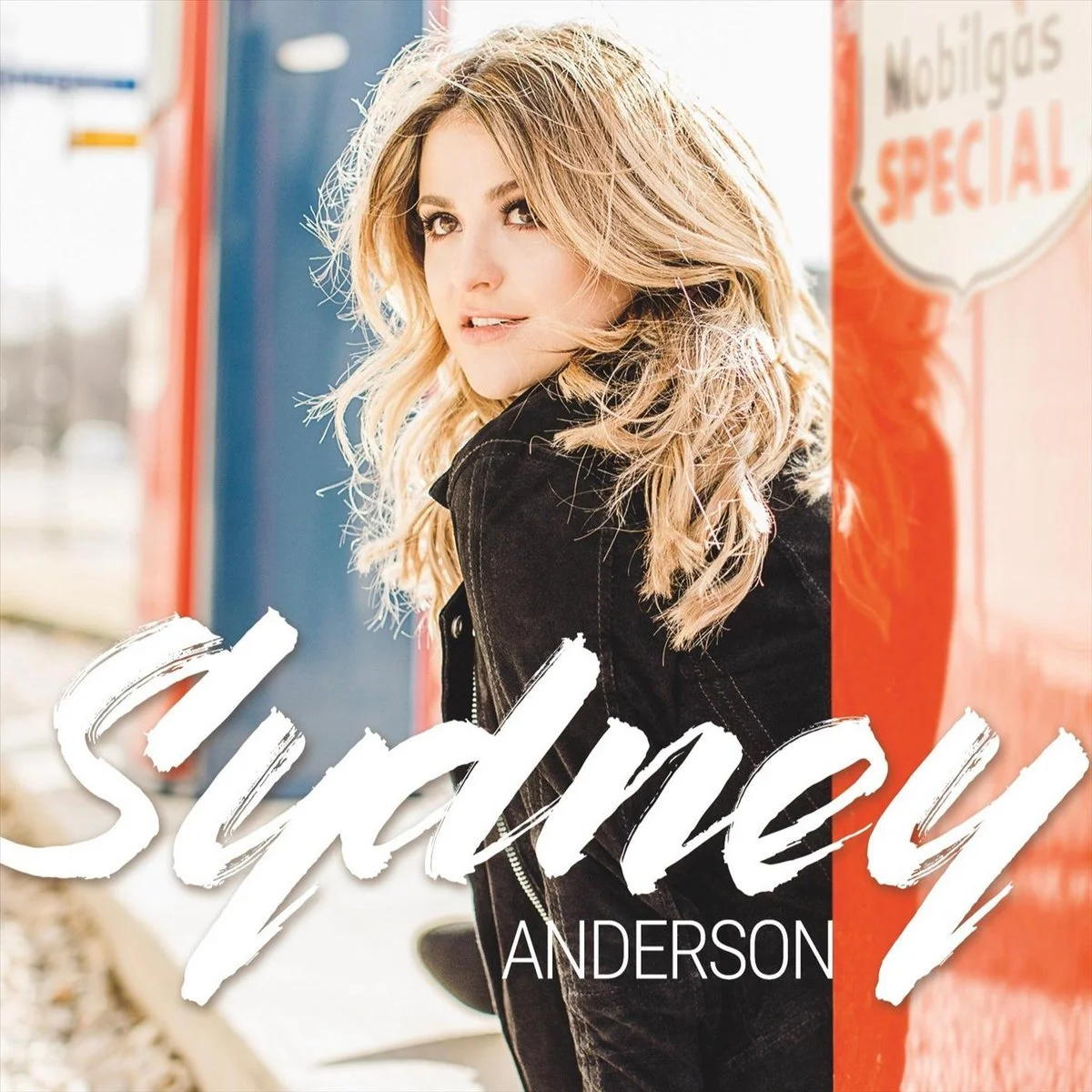 Cover of a book titled "Suddenly" by Anderson, featuring a young woman with blonde wavy hair, wearing a black jacket, standing outdoors next to a red and blue background with the words "Mobilgas Special" visible.