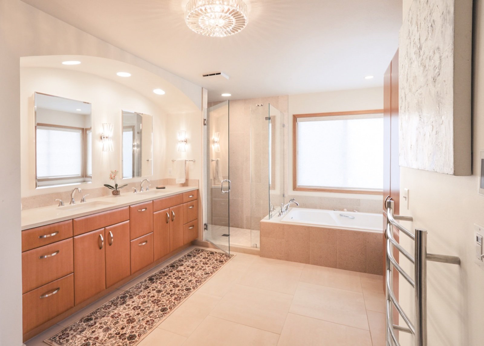 Modern bathroom with double vanity, mirrors, lighting fixtures, a shower, a bathtub, and large windows.