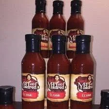 Six bottles of Mario Alfredo Original hot sauce arranged in two rows, with three bottles in each row.