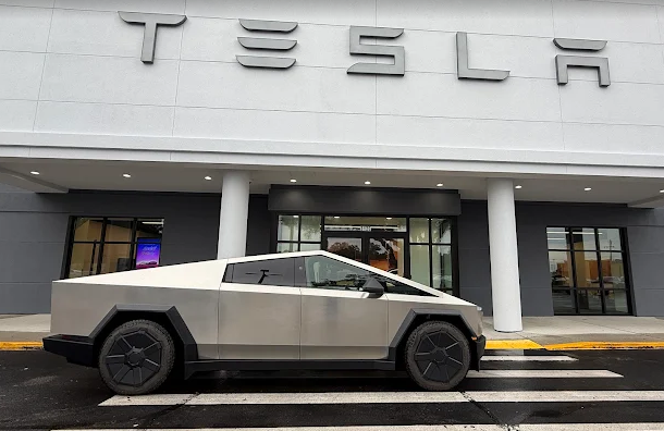 Our DST offering Tesla Pensacola - A Tesla Cybertruck parked in front of a Tesla dealership.