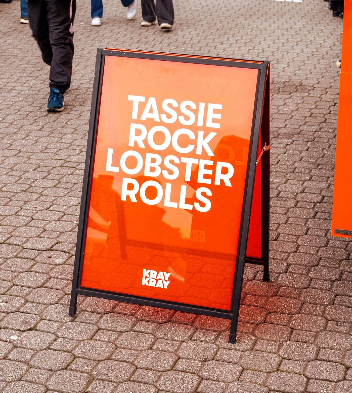A red translucent a-frame advertising Tassie rock lobster rolls for Kray Kray in Nipaluna/Hobart, Tasmania.