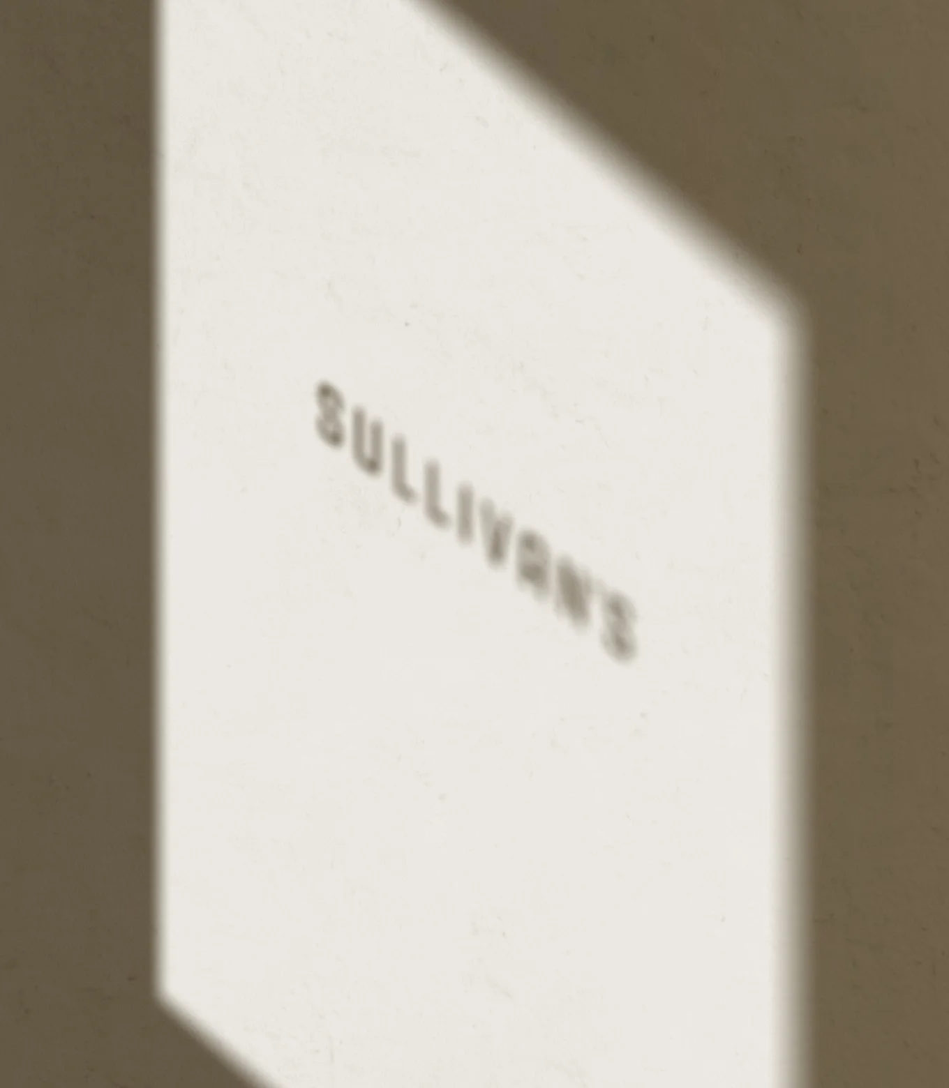 Shadow of the Sullivan's logo on the front door