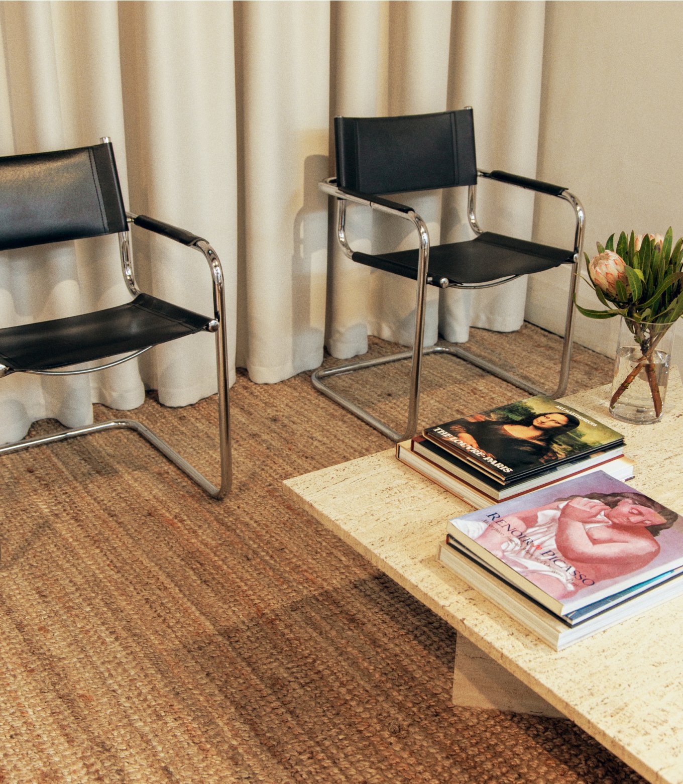 Sullivan Tailors interior with black leather chairs and magazines on a coffee table
