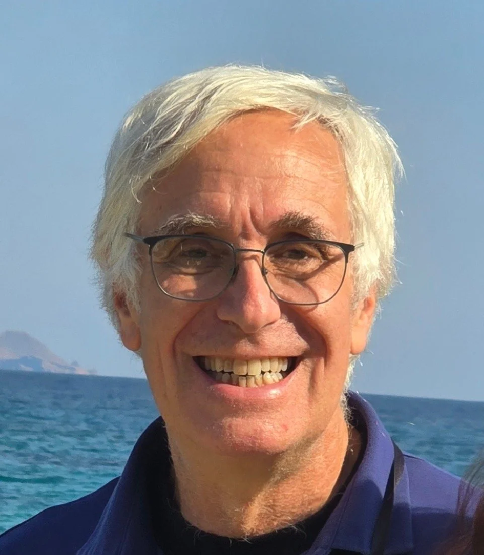 Headshot of man with white hair