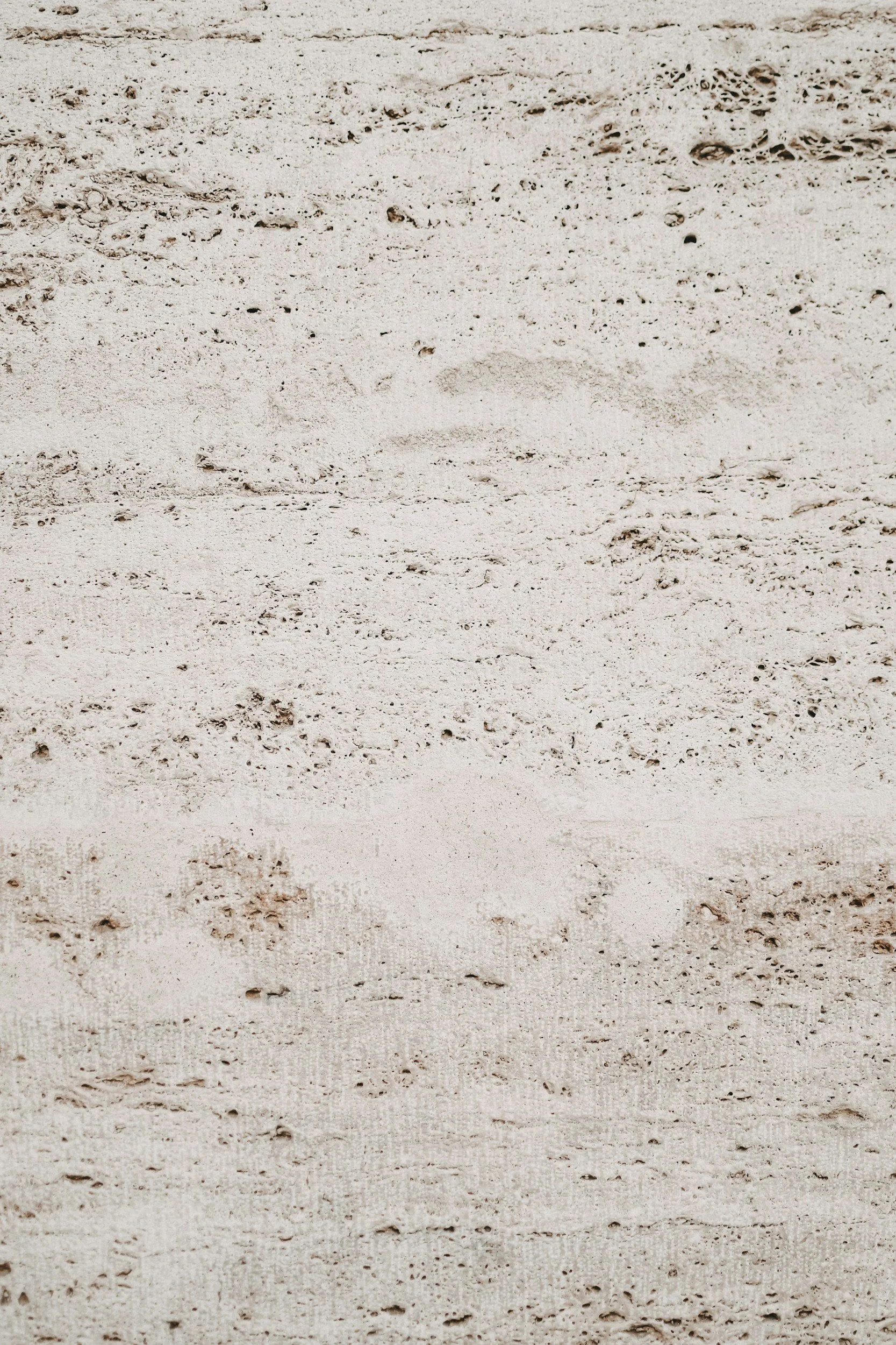 Close-up of a sandy beach with visible footprints and textured sand.