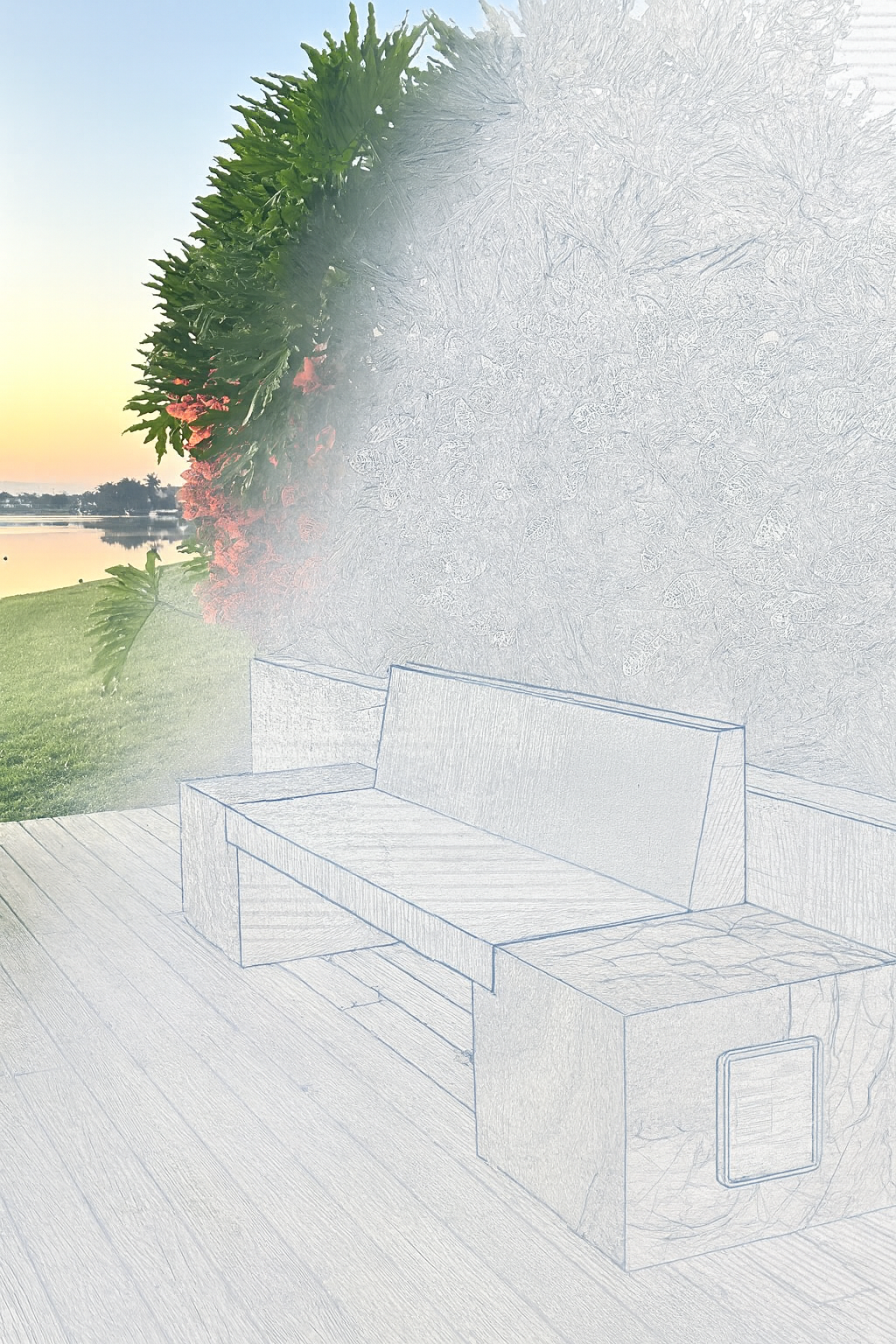 A partly sketched outdoor bench next to a stone firepit on a wooden deck, with a large flowering bush, green grass, and a lake in the background during sunset.